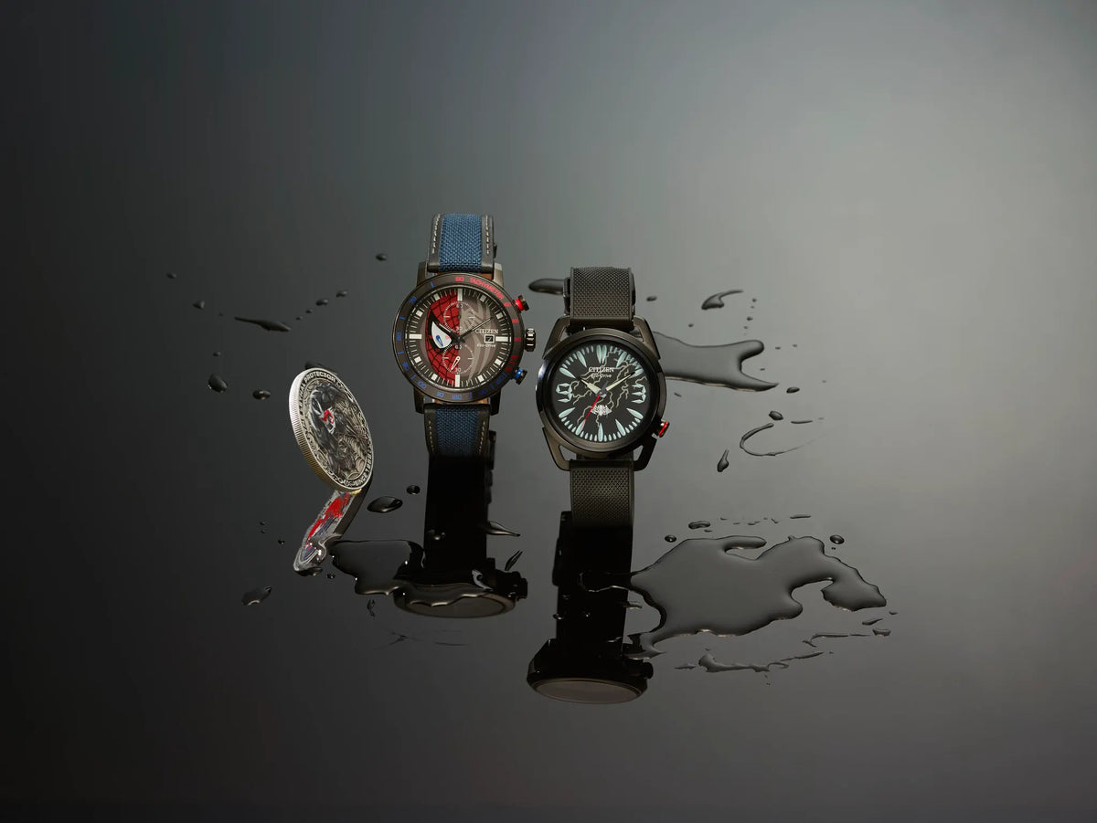 Citizen Spider-Man Double Vision CA0855-47W displayed with Marvel Citizen watches and collectible coin on a glossy black surface with water-like effects.