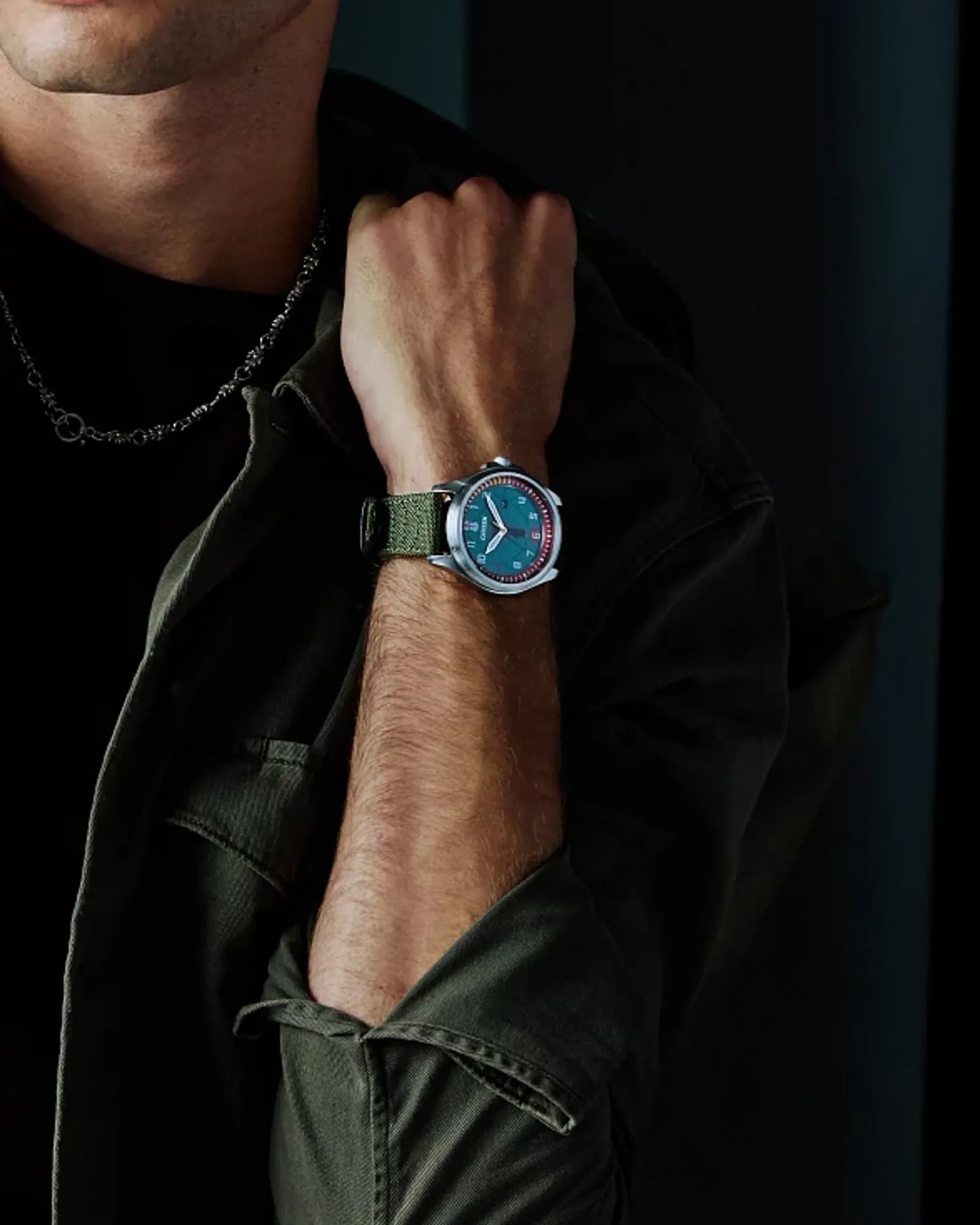 Person wearing a watch with a dark background