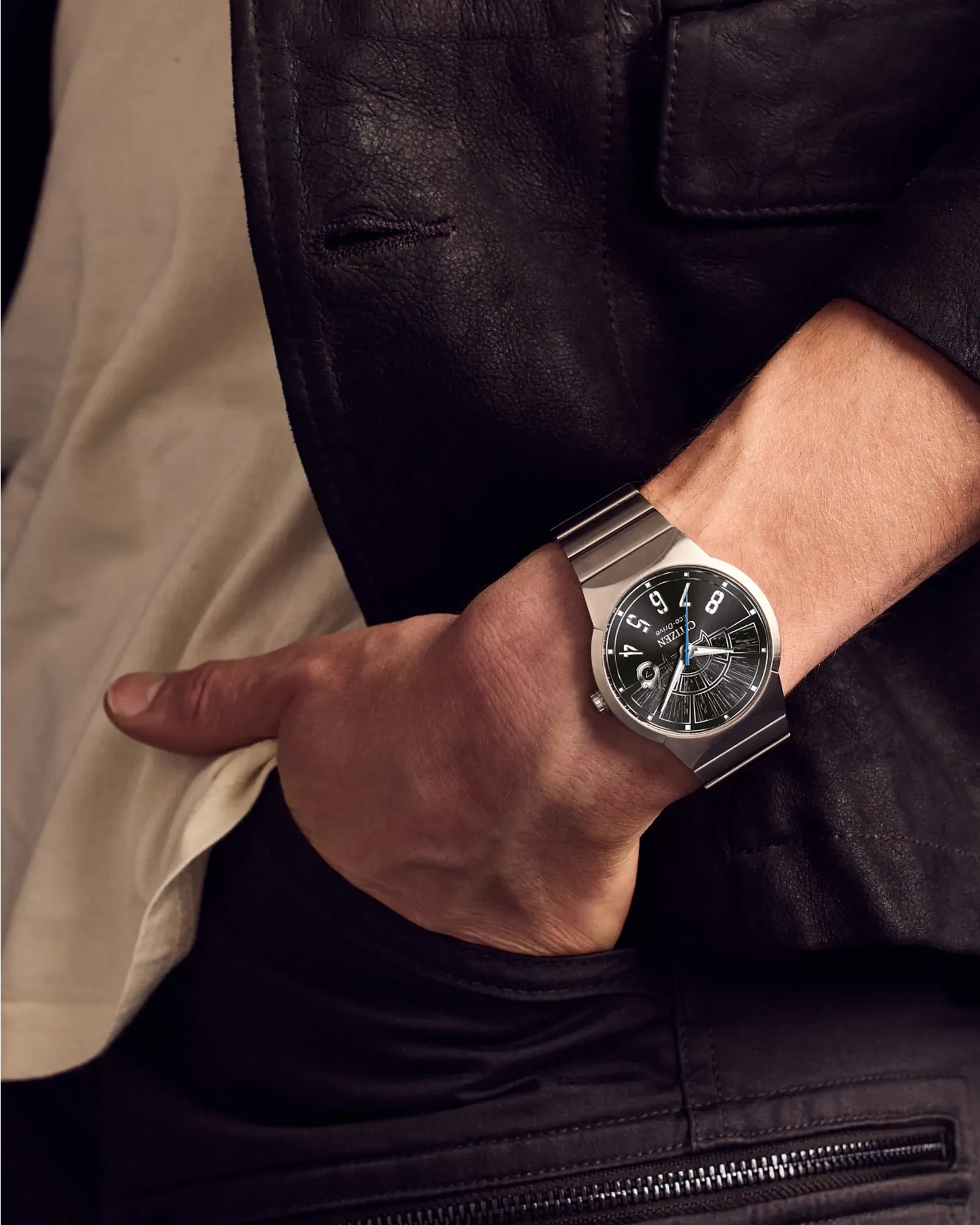 Close-up of a person's wrist wearing a silver watch with a dark face.