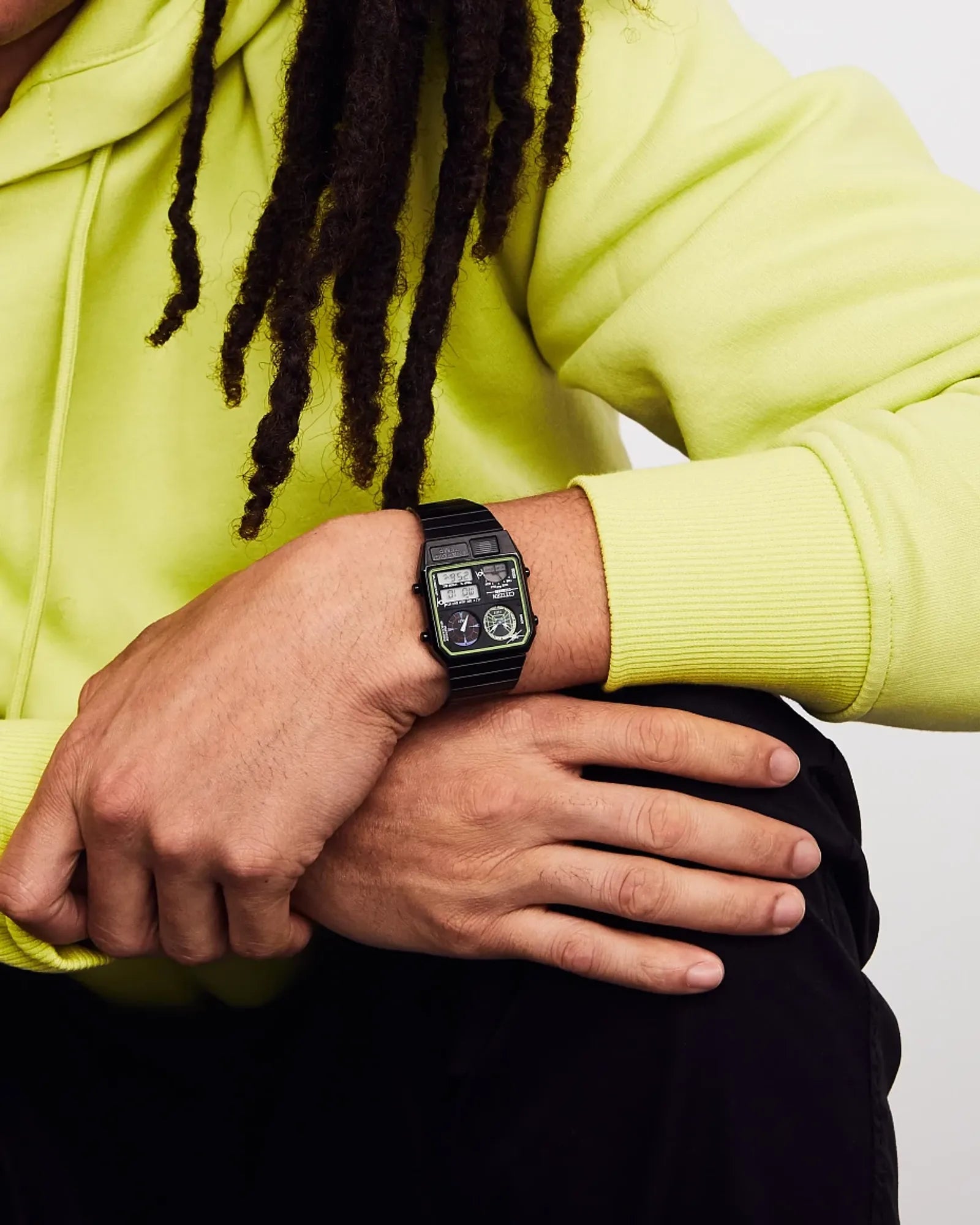 Person wearing a black watch with a white background