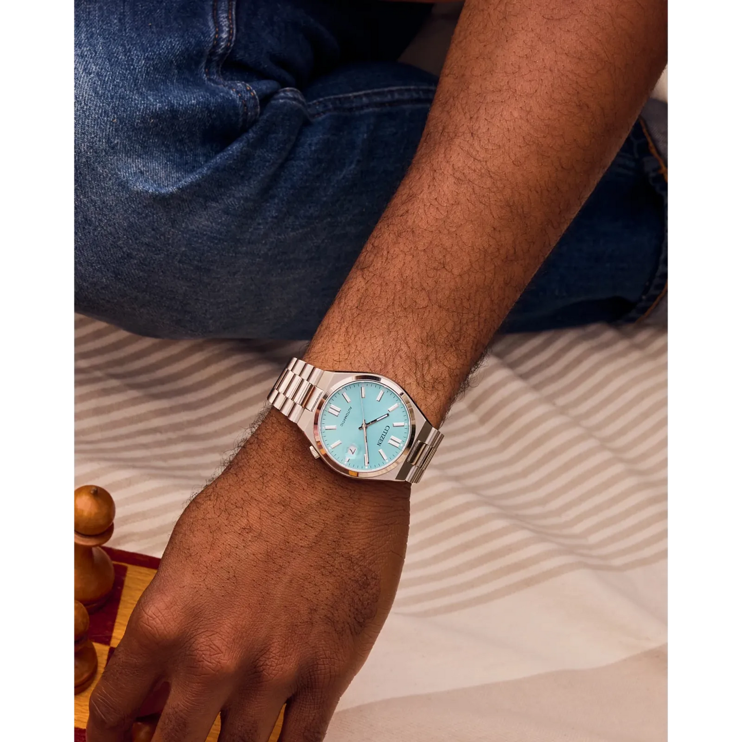 Citizen TSUYOSA NJ0200-50L – 37mm silver-tone stainless steel case, sunray ice blue dial, automatic movement, sapphire crystal, stainless steel bracelet, and 50m water resistance.