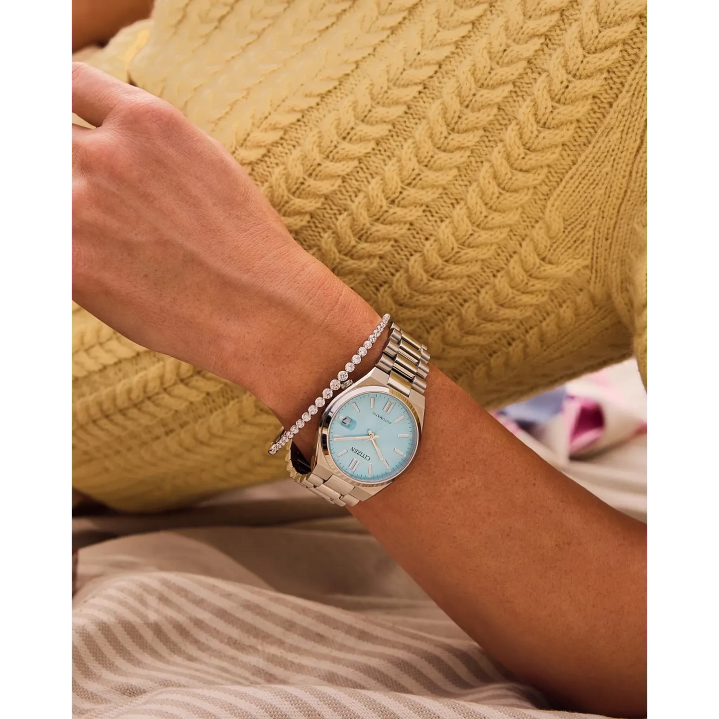 Citizen TSUYOSA NJ0200-50L – 37mm silver-tone stainless steel case, sunray ice blue dial, automatic movement, sapphire crystal, stainless steel bracelet, and 50m water resistance.