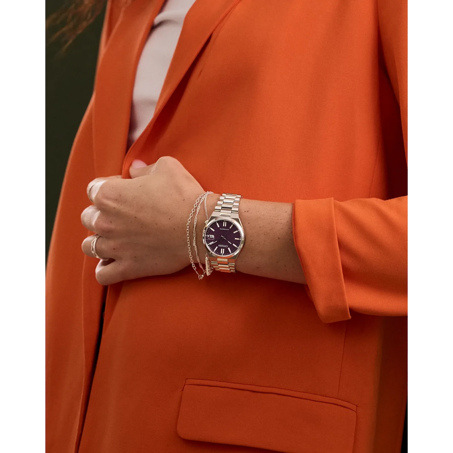 Citizen TSUYOSA NJ0200-50W – 37mm silver-tone stainless steel case, bold purple dial, automatic movement, sapphire crystal, and stainless steel bracelet with 50m water resistance.”