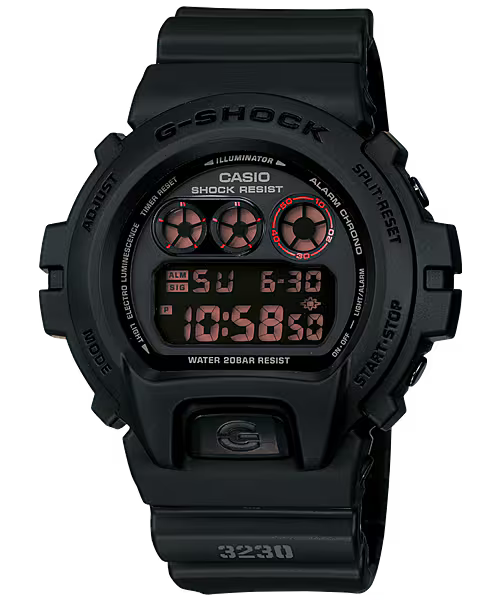 Casio G-SHOCK DW6900MS-1 digital watch in stealth matte black resin case and band with red accents and black ion-plated buttons. Features shock resistance, mineral glass, 200-meter water resistance, electro-luminescent blue-green backlight with afterglow, stopwatch, countdown timer, multi-function alarm, hourly time signal, flash alert, full auto-calendar, and 12/24-hour format. Case size 53.2 × 50 × 18.7 mm, weight 67 g, powered by CR2016 battery with approx. 2-year life.”