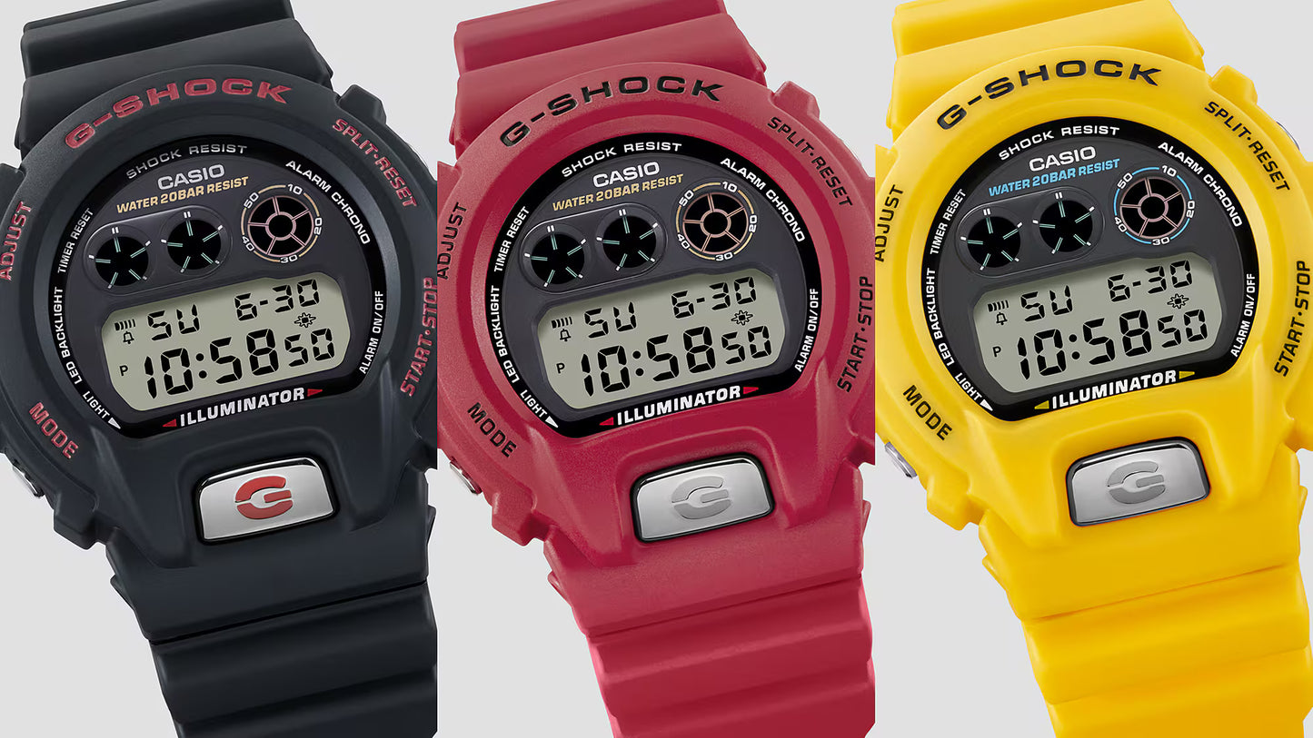 Three Casio G-Shock watches in black, red, and yellow on a light gray background.