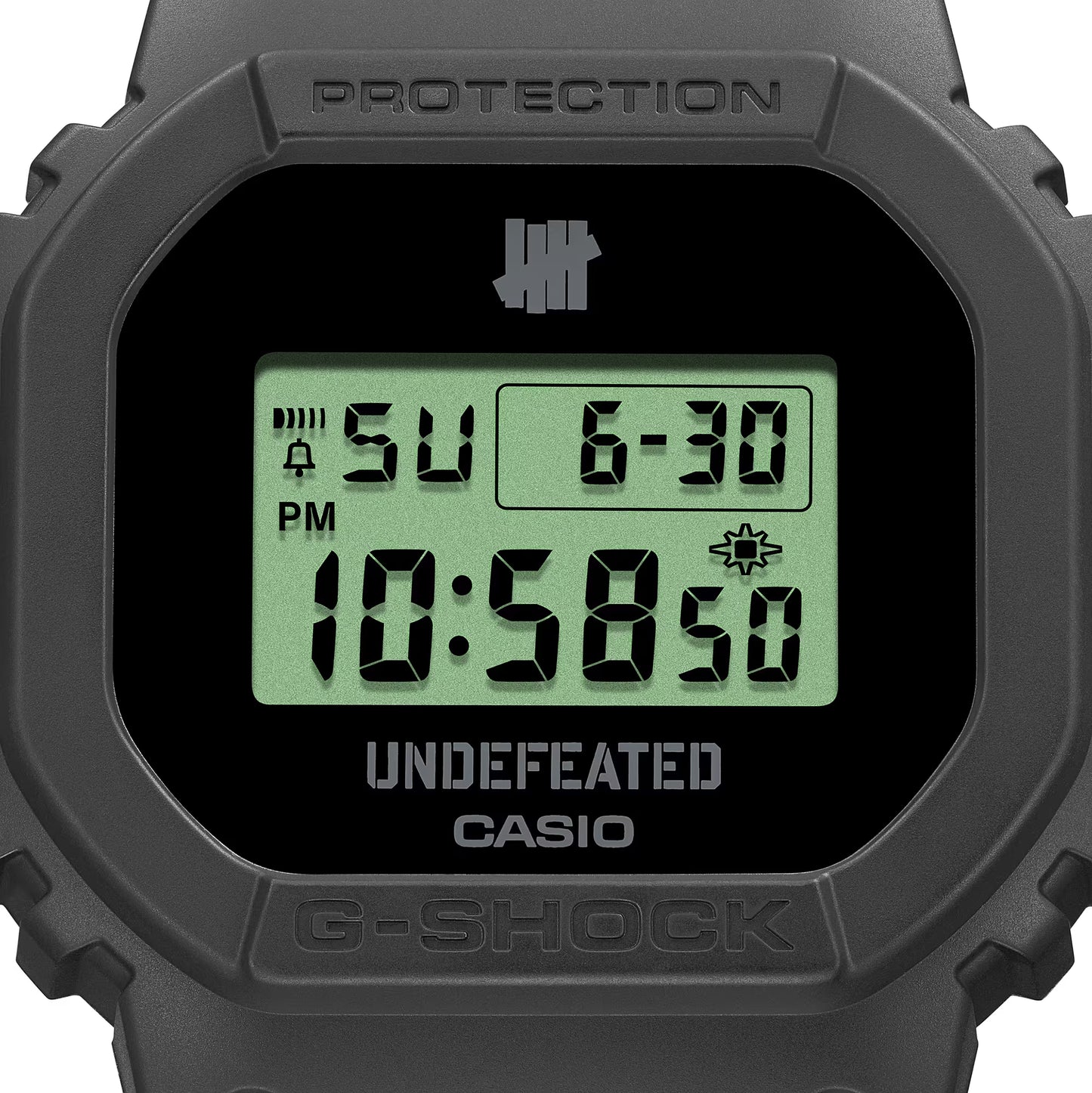 Casio G-SHOCK DWE5600UD-1 UNDEFEATED collaboration model with matte black Carbon Core Guard case, semi-translucent resin band featuring UNDEFEATED logo, green LCD display, engraved caseback, and special packaging. Includes two interchangeable camouflage straps (tiger camo, storm camo). Features shock resistance, mineral glass, 200m water resistance, LED Super Illuminator backlight, stopwatch, countdown timer, alarms, flash alert, auto-calendar, and ±15 sec/month accuracy. Case size 48.9 × 43.8 × 13.7 mm, we