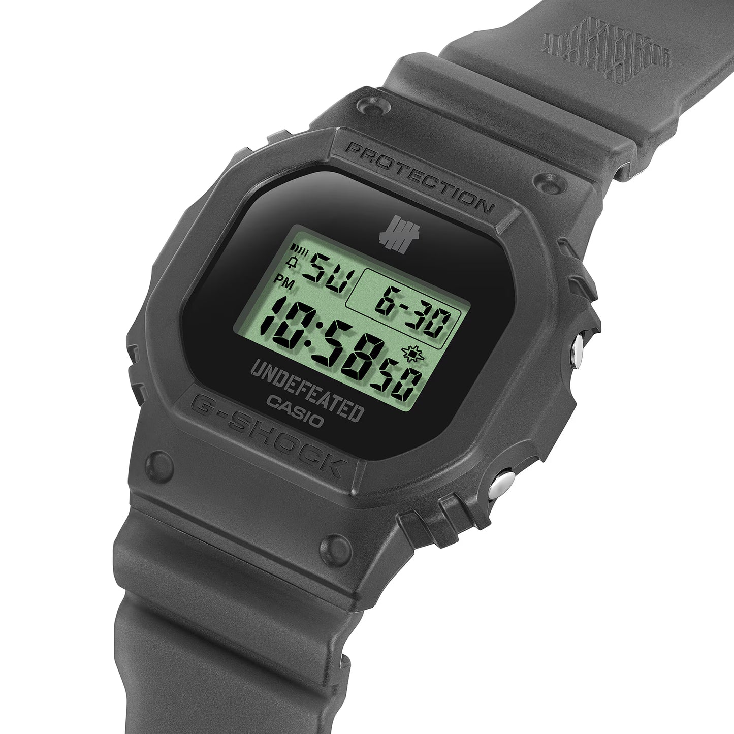 Gray Casio G-Shock digital watch with green display on a white background