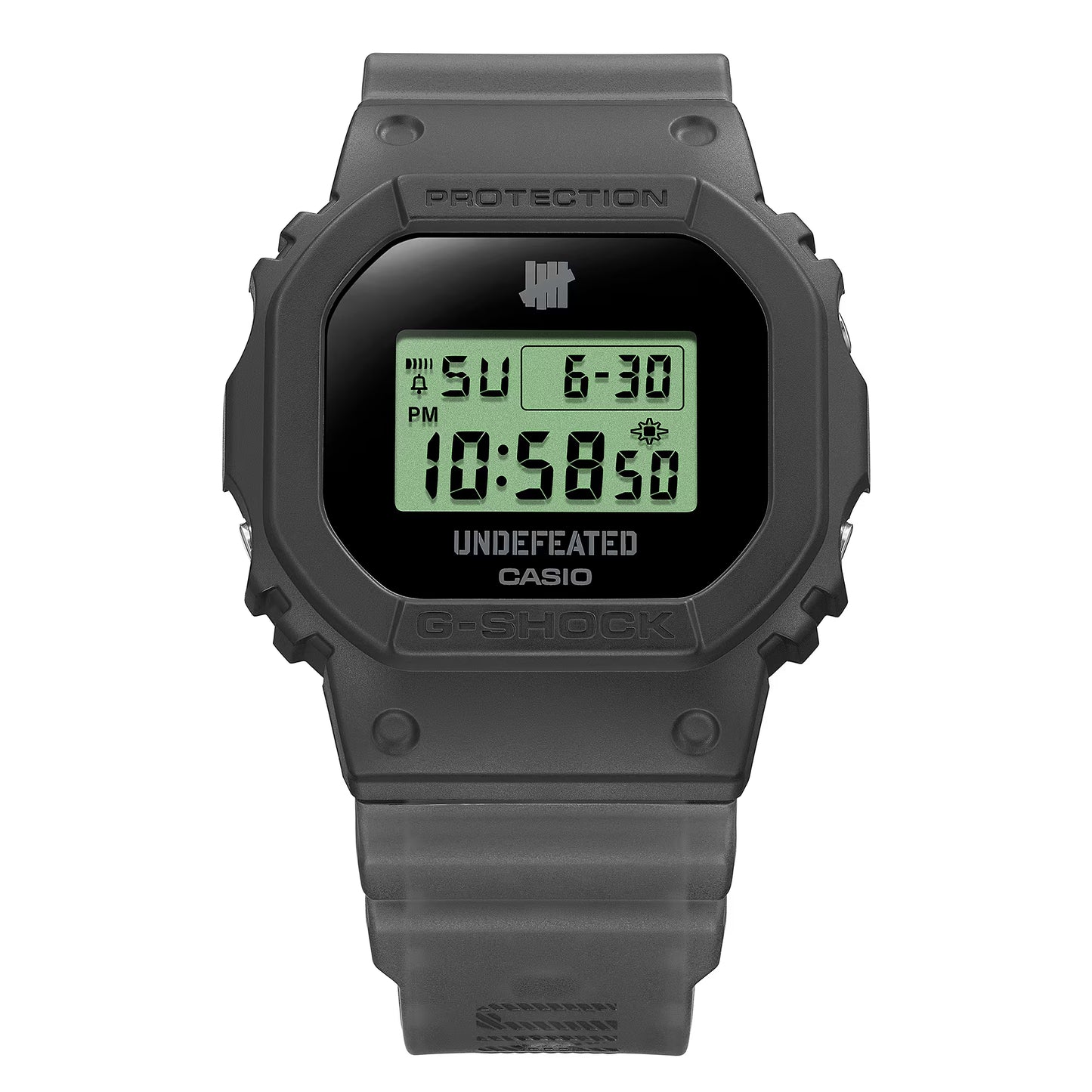 Casio G-SHOCK DWE5600UD-1 UNDEFEATED collaboration model with matte black Carbon Core Guard case, semi-translucent resin band featuring UNDEFEATED logo, green LCD display, engraved caseback, and special packaging. Includes two interchangeable camouflage straps (tiger camo, storm camo). Features shock resistance, mineral glass, 200m water resistance, LED Super Illuminator backlight, stopwatch, countdown timer, alarms, flash alert, auto-calendar, and ±15 sec/month accuracy. Case size 48.9 × 43.8 × 13.7 mm, we