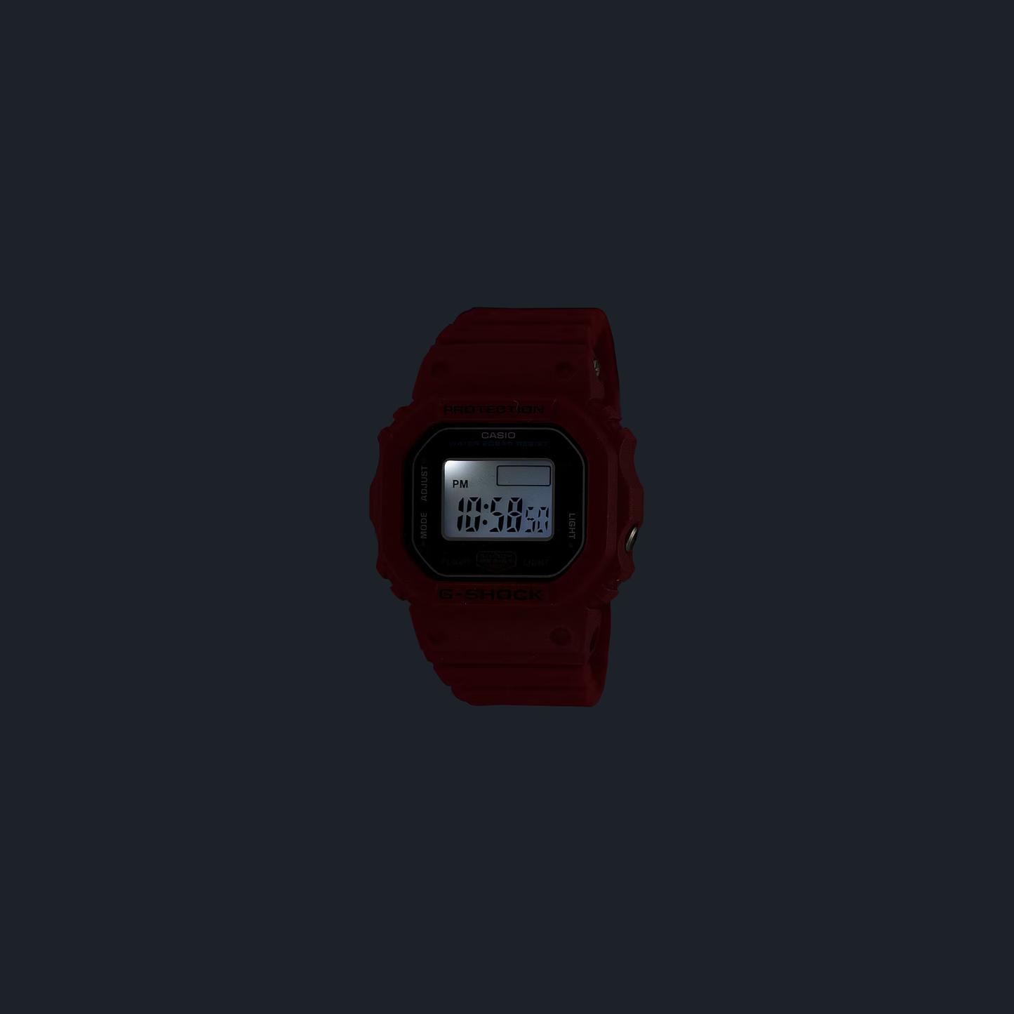 Casio G-SHOCK Nano DWN5600-4 miniature watch. 1/10-scale red version of the DW-5600 made from sustainable bio-based resin. Features 23.4 × 20 × 7.5 mm case, 6 g weight, LED backlight with time flash, dual time, stopwatch, and auto-calendar. Shock resistant and 200-meter water resistant. Includes special silicone display stand and approx. 2-year SR621SW battery
