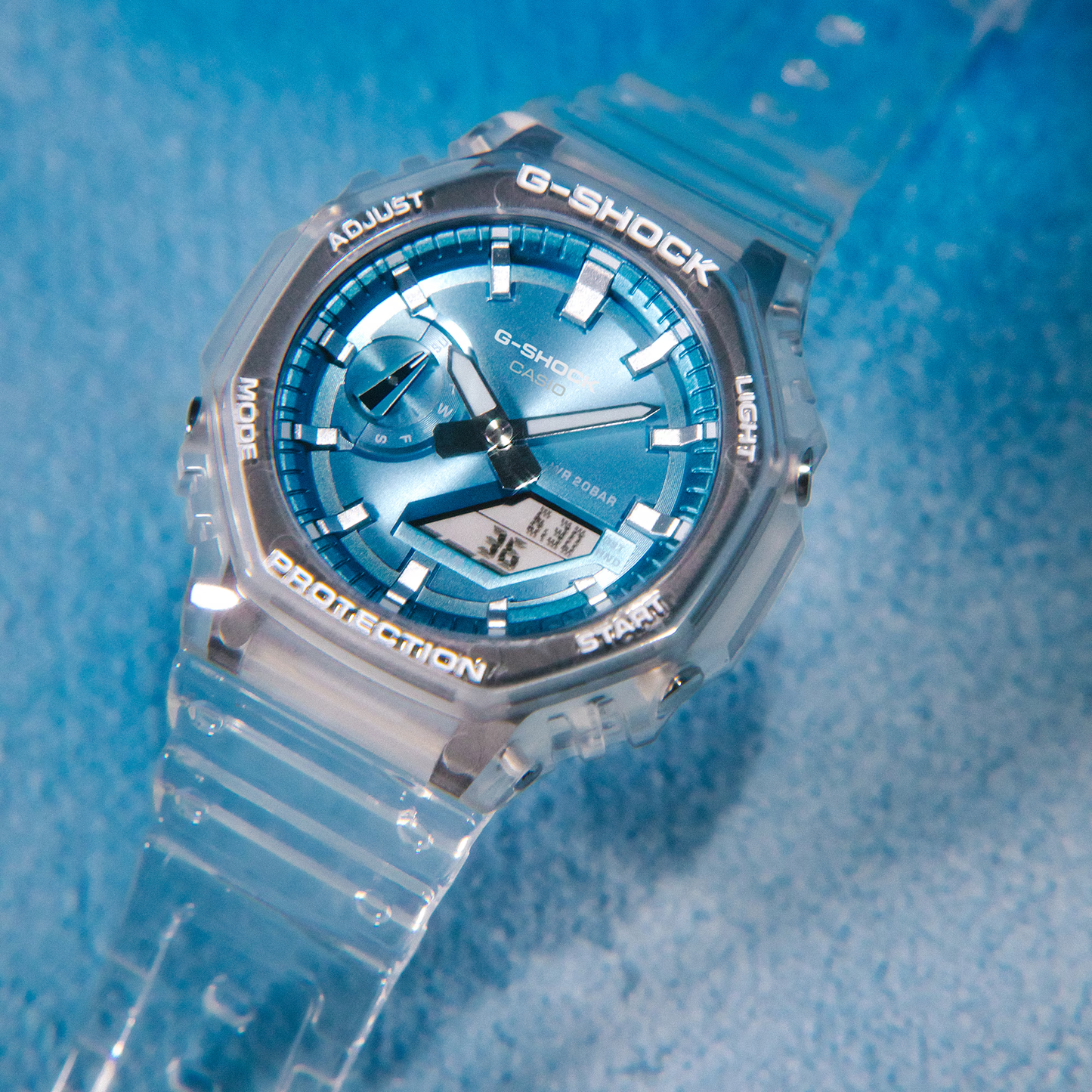 Casio G-Shock GA2100BM-7A2 watch with translucent resin case and band, metallic sky-blue dial, octagonal bezel, and Carbon Core Guard construction