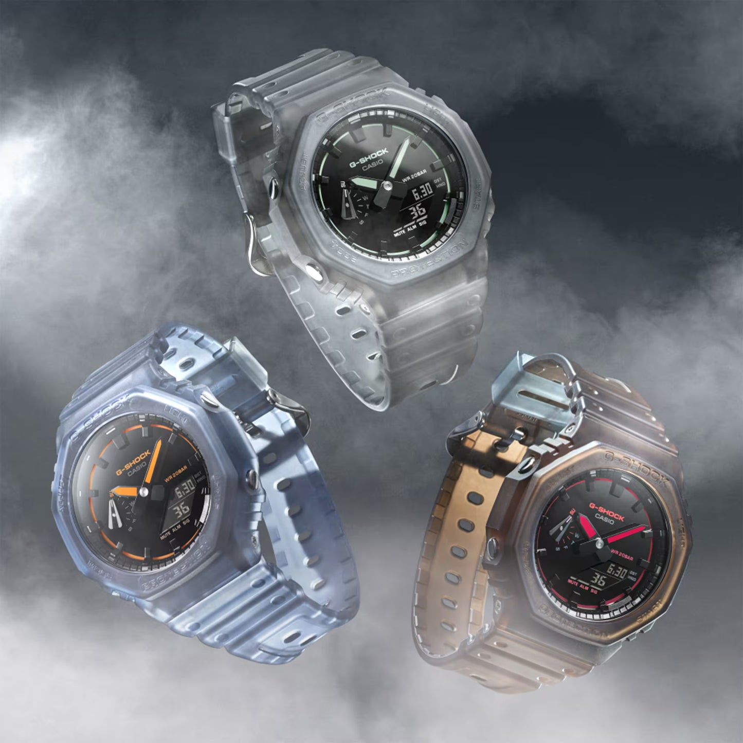 Three Casio G-Shock watches with different designs on a foggy background