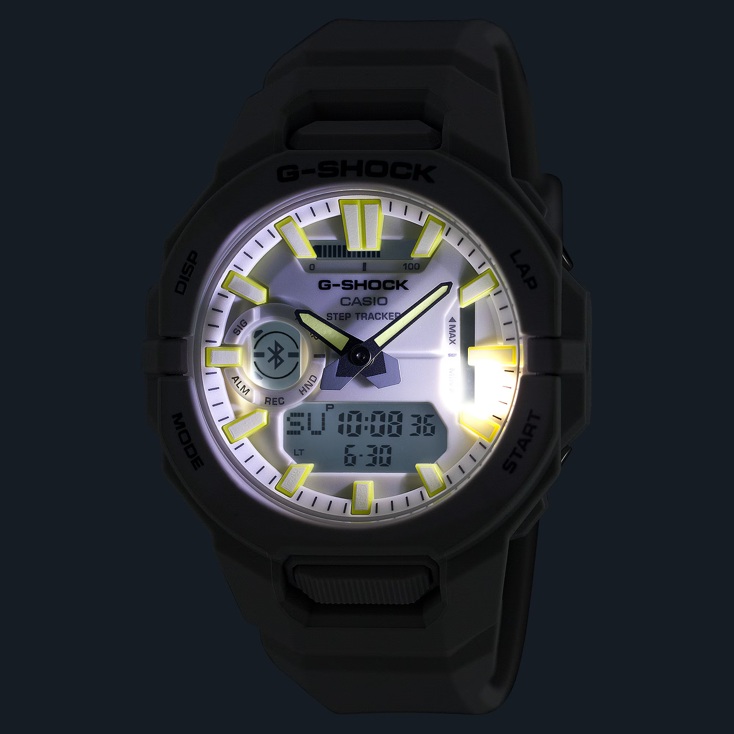 G-Shock watch with black strap and illuminated face on dark background