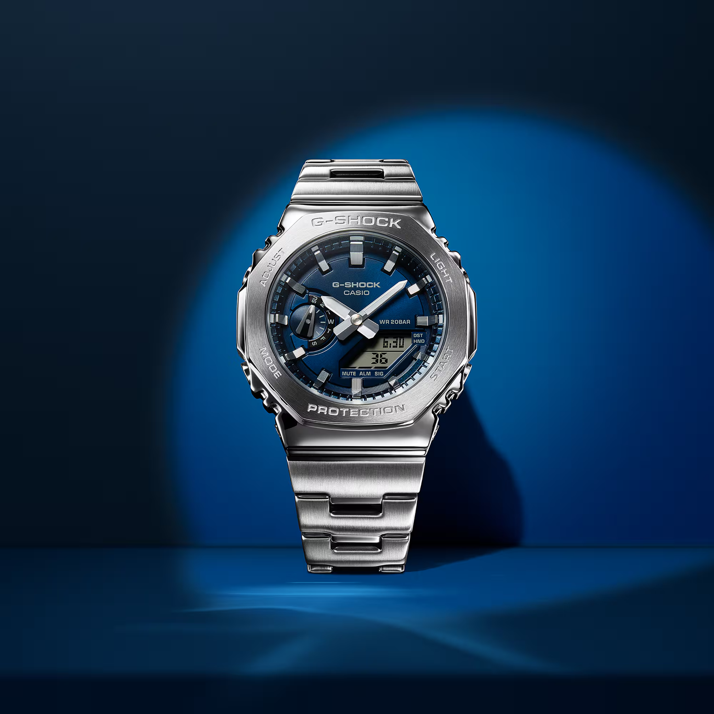 Casio G-STEEL GM2110D-2B, premium stainless-steel G-SHOCK with an octagonal bezel. Features a metallic navy-blue dial, shock resistance, 200m water resistance, dual LED Super Illuminator, and world time. Stylish and durable.