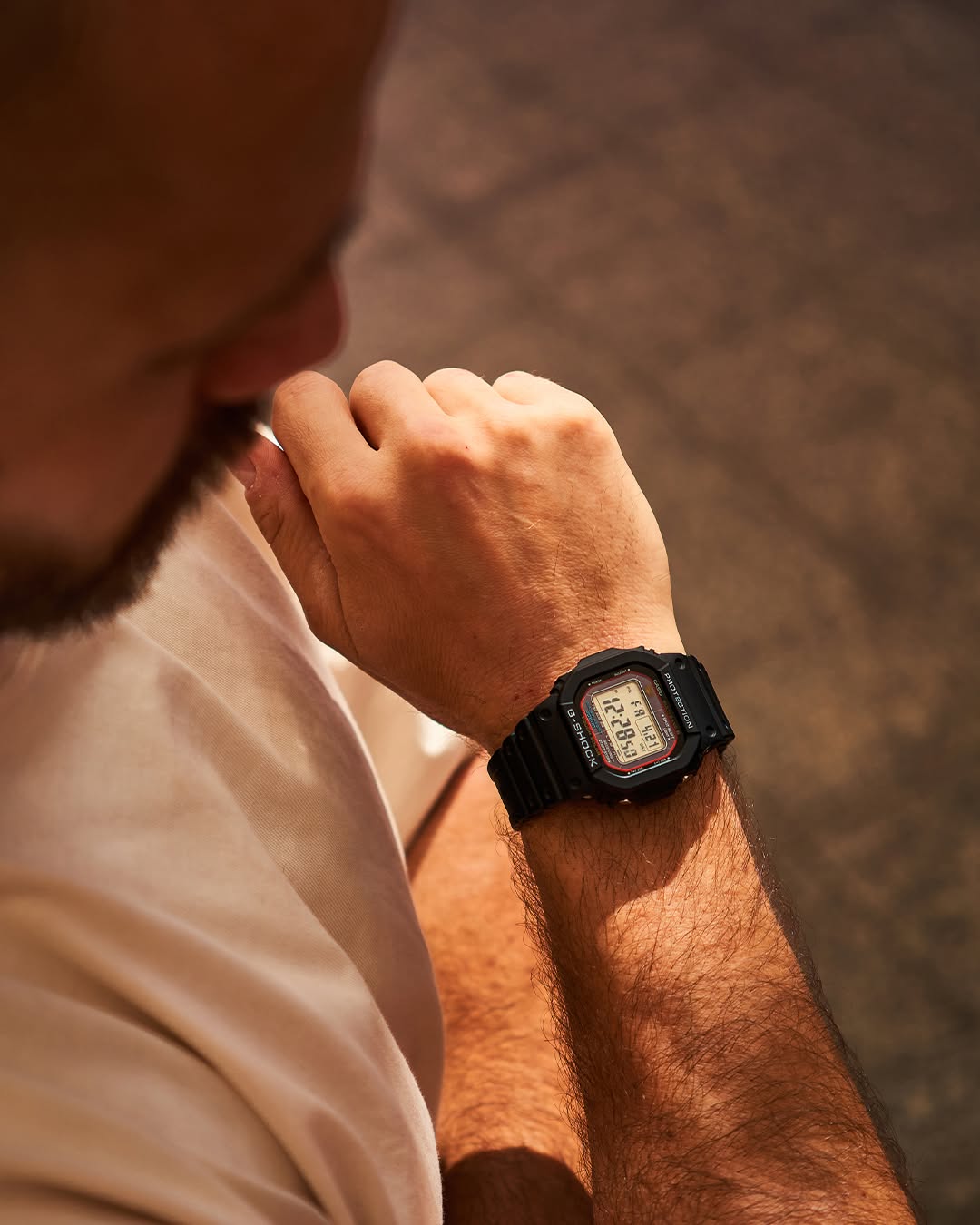 Casio G-Shock GWM5610-1 digital watch with a classic square design. Features solar power, Multi-Band 6 atomic timekeeping, 200m water resistance, shock resistance, and LED backlight.