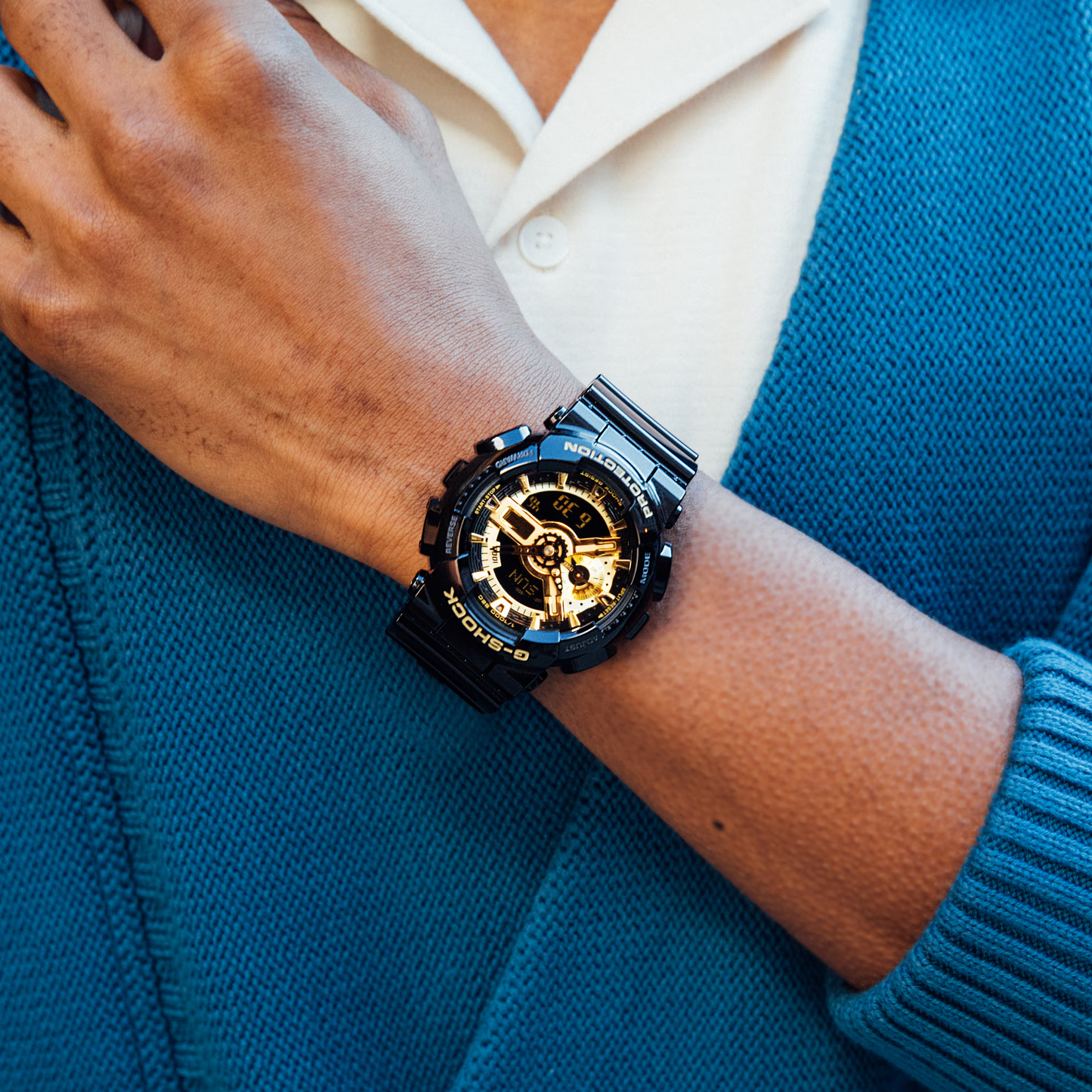 Casio G-SHOCK GA-110 Series GA110GB-1A – glossy black-and-gold design with 3D dial, speedometer function, magnetic resistance, shock resistance, and 200m water resistance.