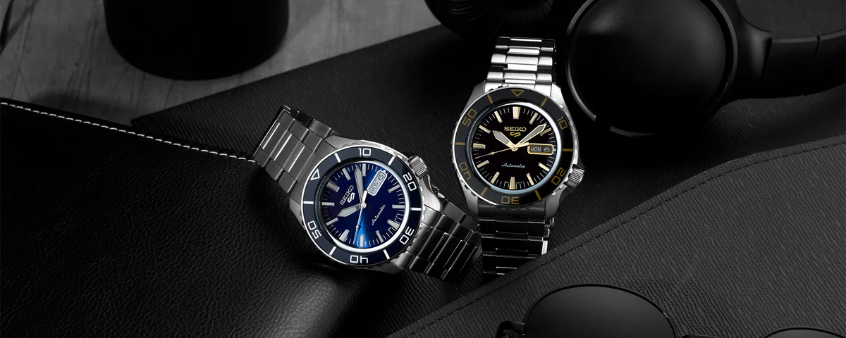 Seiko 5 Sports SRPK99 – black dial with gold accents, rotating bezel, stainless steel case and bracelet, automatic 4R36 movement, and see-through caseback with 100m water resistance