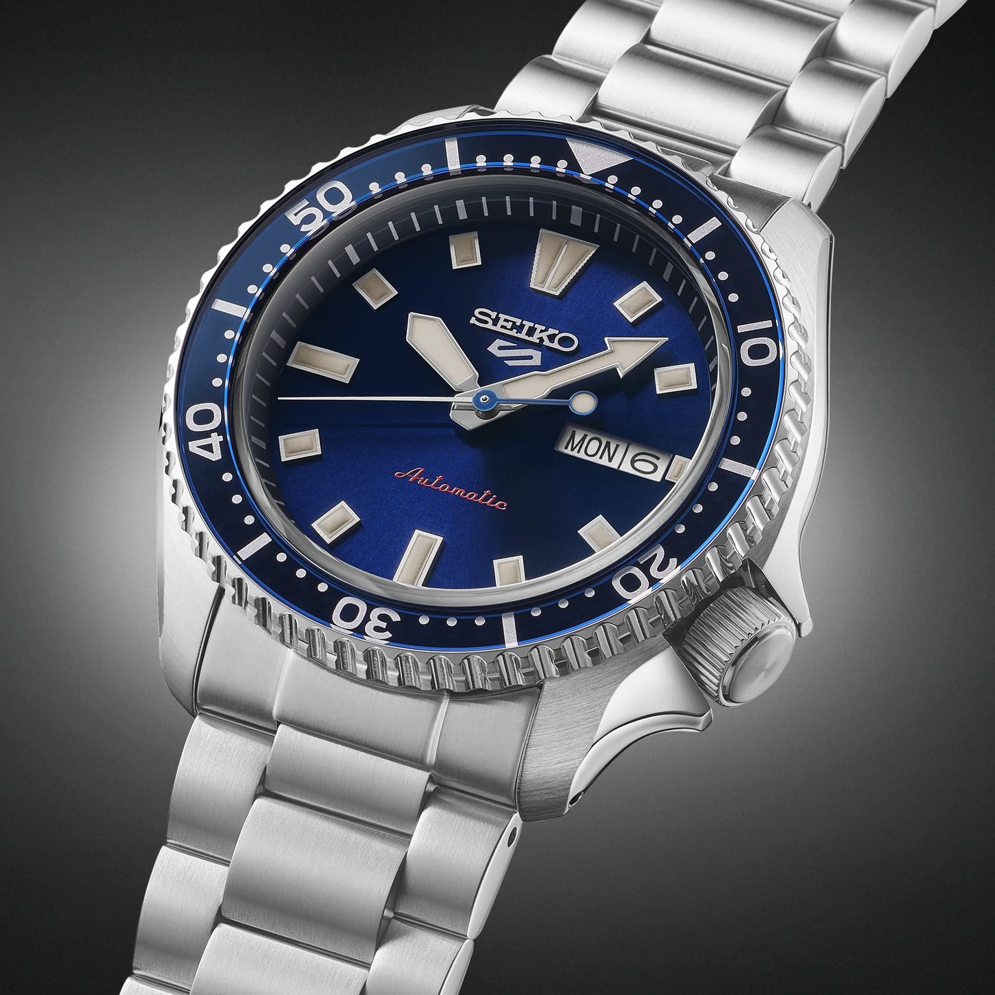 SEIKO 5 Sports SRPL83 SKX Sports Style – deep blue dial and bezel, stainless steel bracelet, automatic movement, and 100m water resistance.