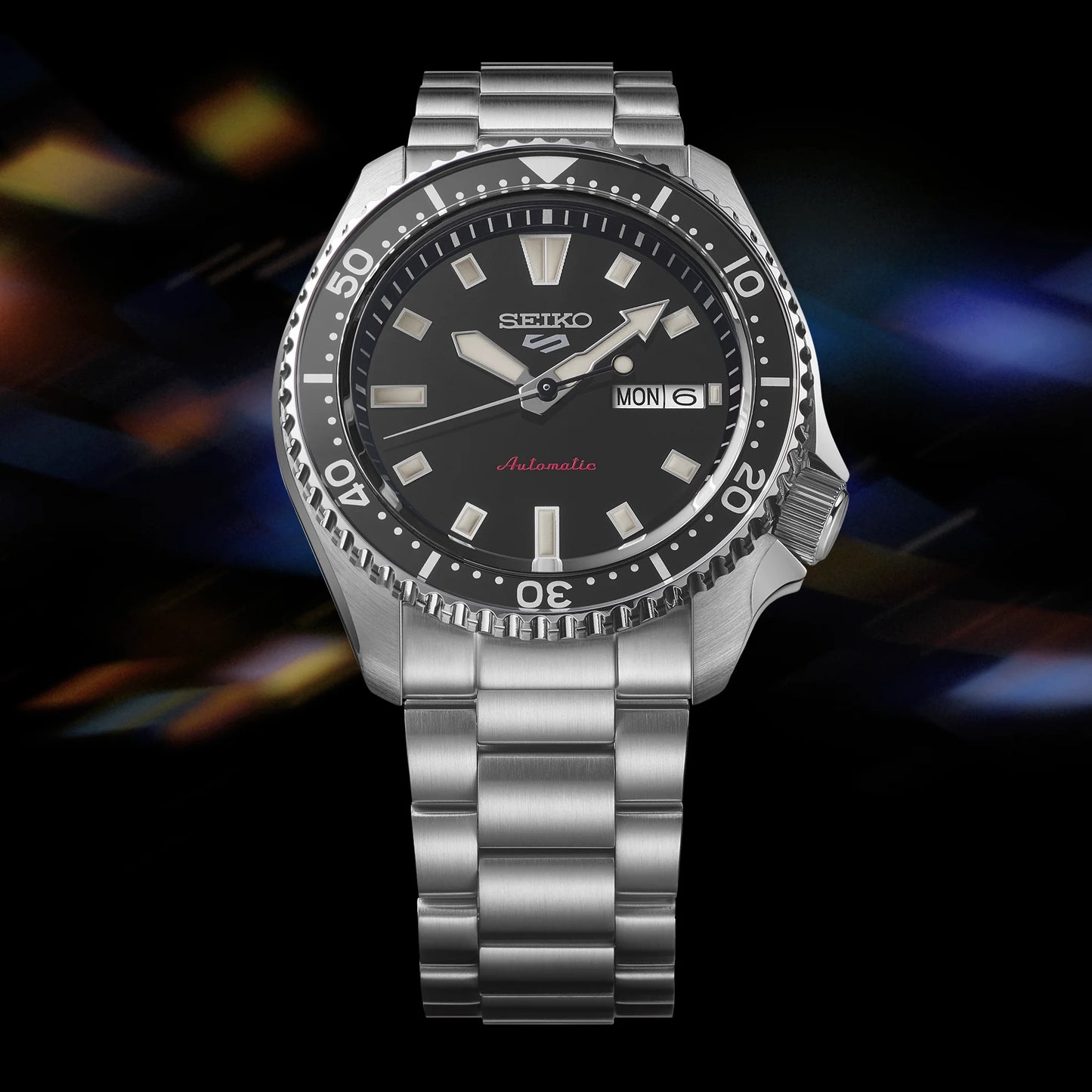 SEIKO 5 Sports SRPL85 SKX Sports Style – black dial and bezel, stainless steel bracelet, automatic movement, and 100m water resistance.
