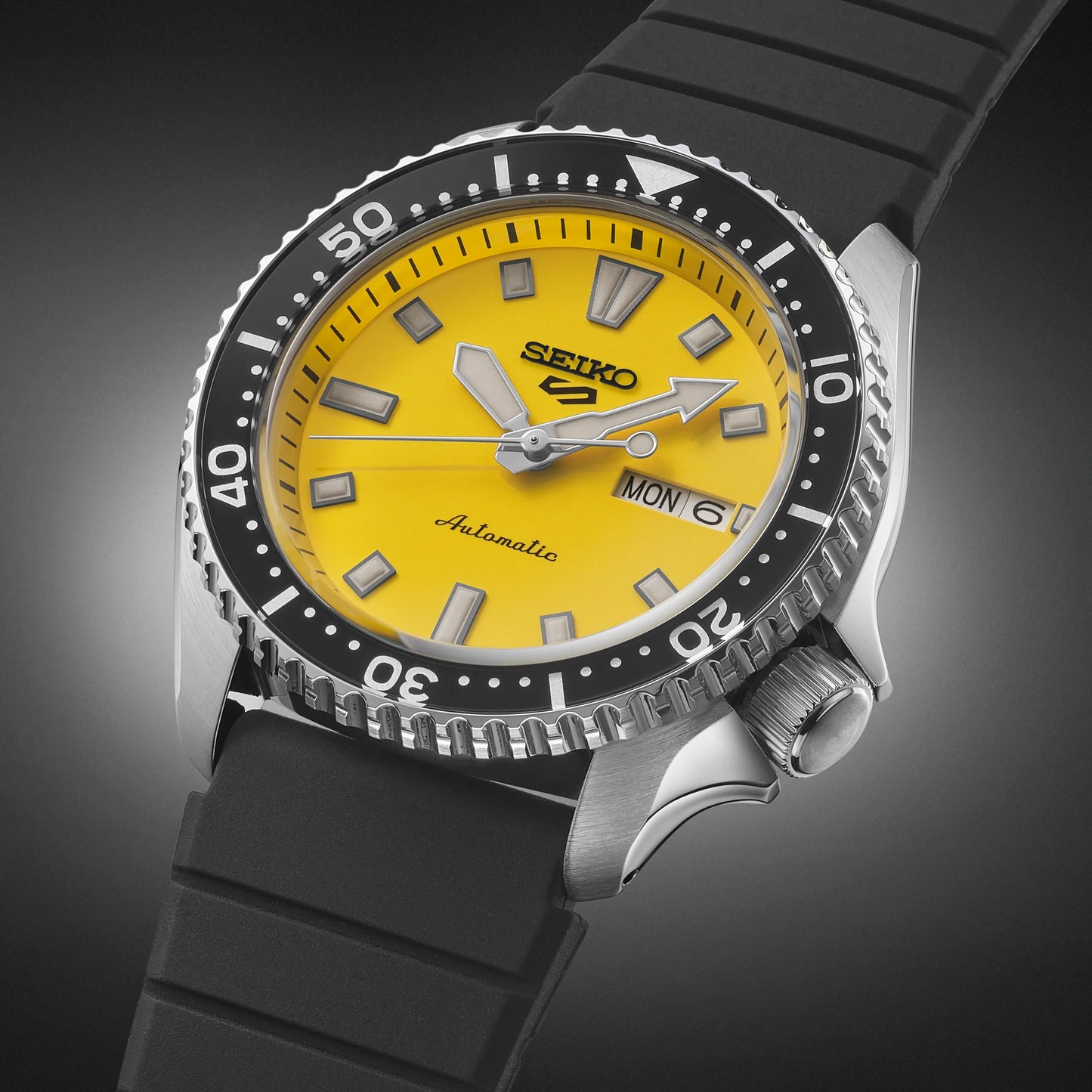 SEIKO 5 Sports SRPL87 SKX Sports Style – bold yellow dial, black rotating bezel, black silicone strap, automatic movement, and 100m water resistance.