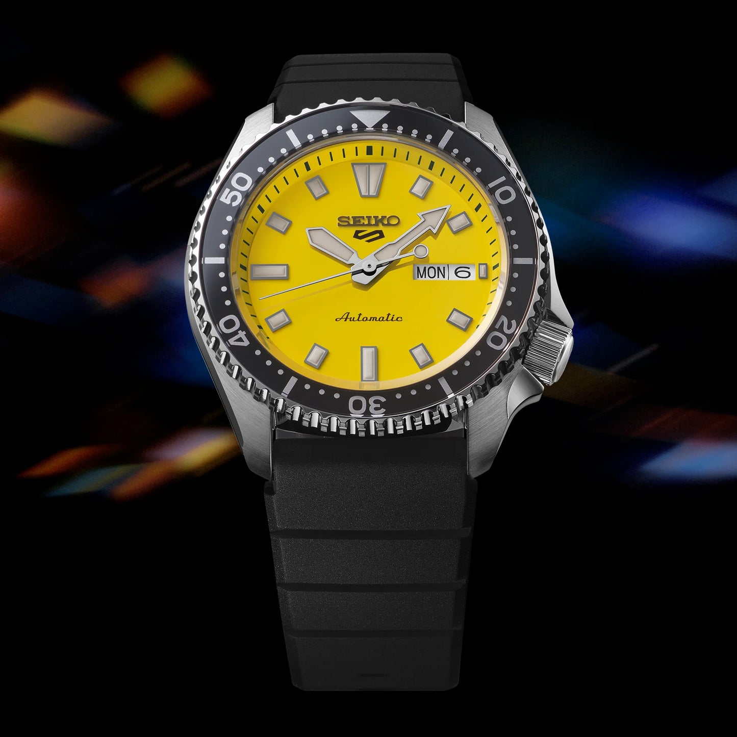 SEIKO 5 Sports SRPL87 SKX Sports Style – bold yellow dial, black rotating bezel, black silicone strap, automatic movement, and 100m water resistance.