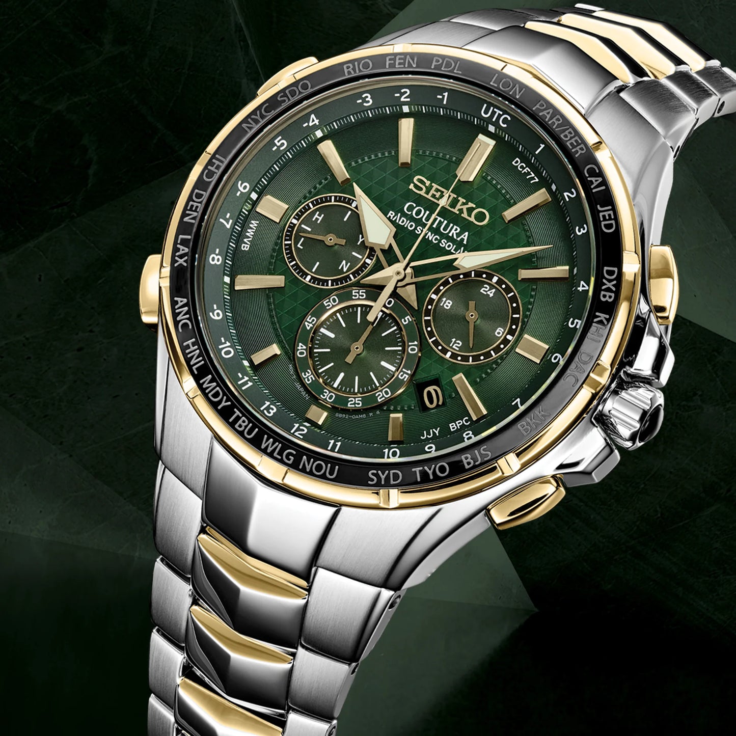 Seiko watch with green face and silver and gold case on a dark background