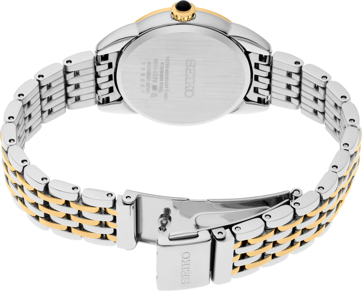 Seiko SUR562 – elegant two-tone stainless steel watch with ivory patterned dial, gold hands, Arabic numerals, cabochon crown, and curved Hardlex crystal from the Essentials Collection.