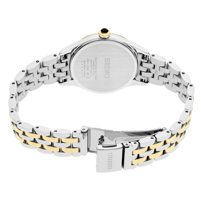 Seiko SUR612 Essentials – two-tone stainless steel quartz watch with white Roman numeral dial, gold-tone accents, sapphire crystal, and 50m water resistance.