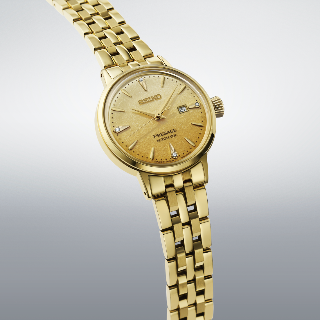 Gold Seiko watch on a gradient gray background