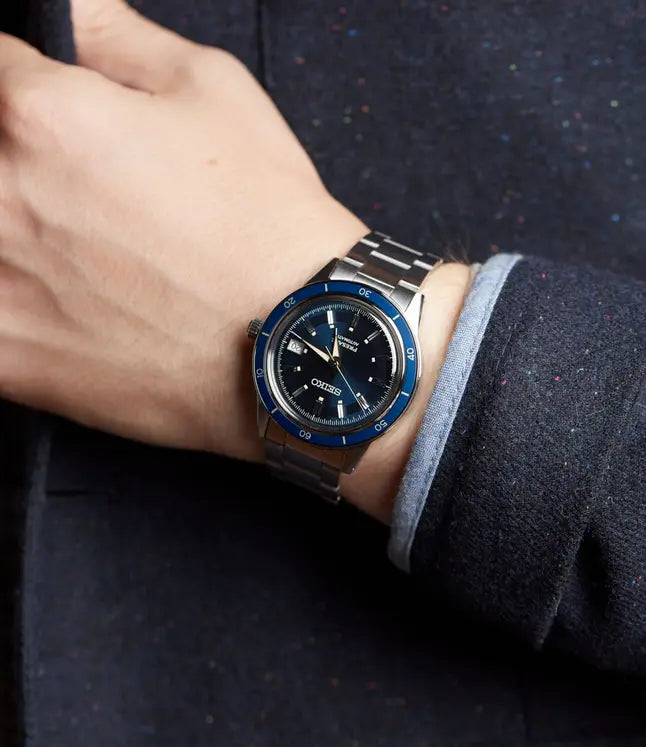 SEIKO SRPG05 from the Presage Style60’s Collection – blue sunray dial with rose gold-accented bezel, beige LumiBrite hands, stainless steel bracelet, automatic 23-jewel movement, and 50m water resistance.