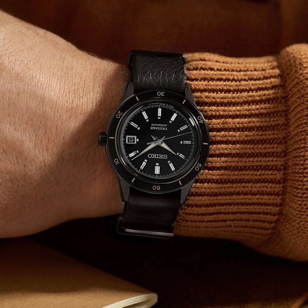 SEIKO SRPH95 from the Presage Style60’s Collection – black dial and bezel, beige LumiBrite hands, black deerskin strap, black hard-coated stainless steel case, automatic movement, and 50m water resistance.