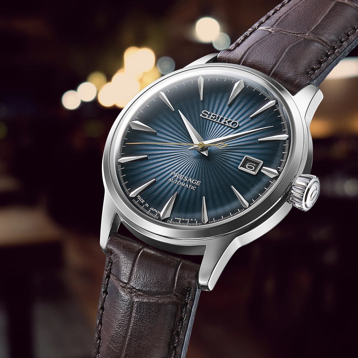 SEIKO Presage Cocktail Time – blue gradated dial inspired by the Blue Moon cocktail, stainless steel case, brown leather strap, automatic 23-jewel movement, and 50m water resistance.