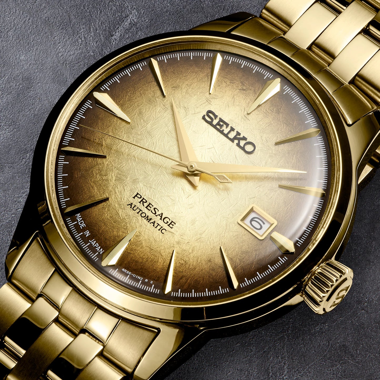 SEIKO Presage Cocktail Time U.S. Special Creation – gold-tone case and bracelet, brown and gold dial inspired by the Half and Half cocktail, automatic movement, and 50m water resistance.