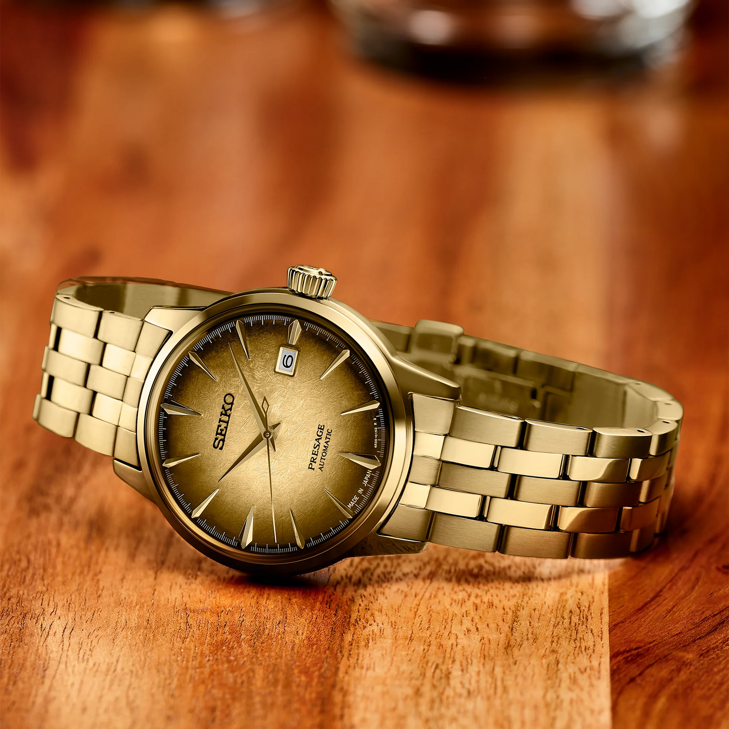 SEIKO Presage Cocktail Time U.S. Special Creation – gold-tone case and bracelet, brown and gold dial inspired by the Half and Half cocktail, automatic movement, and 50m water resistance.