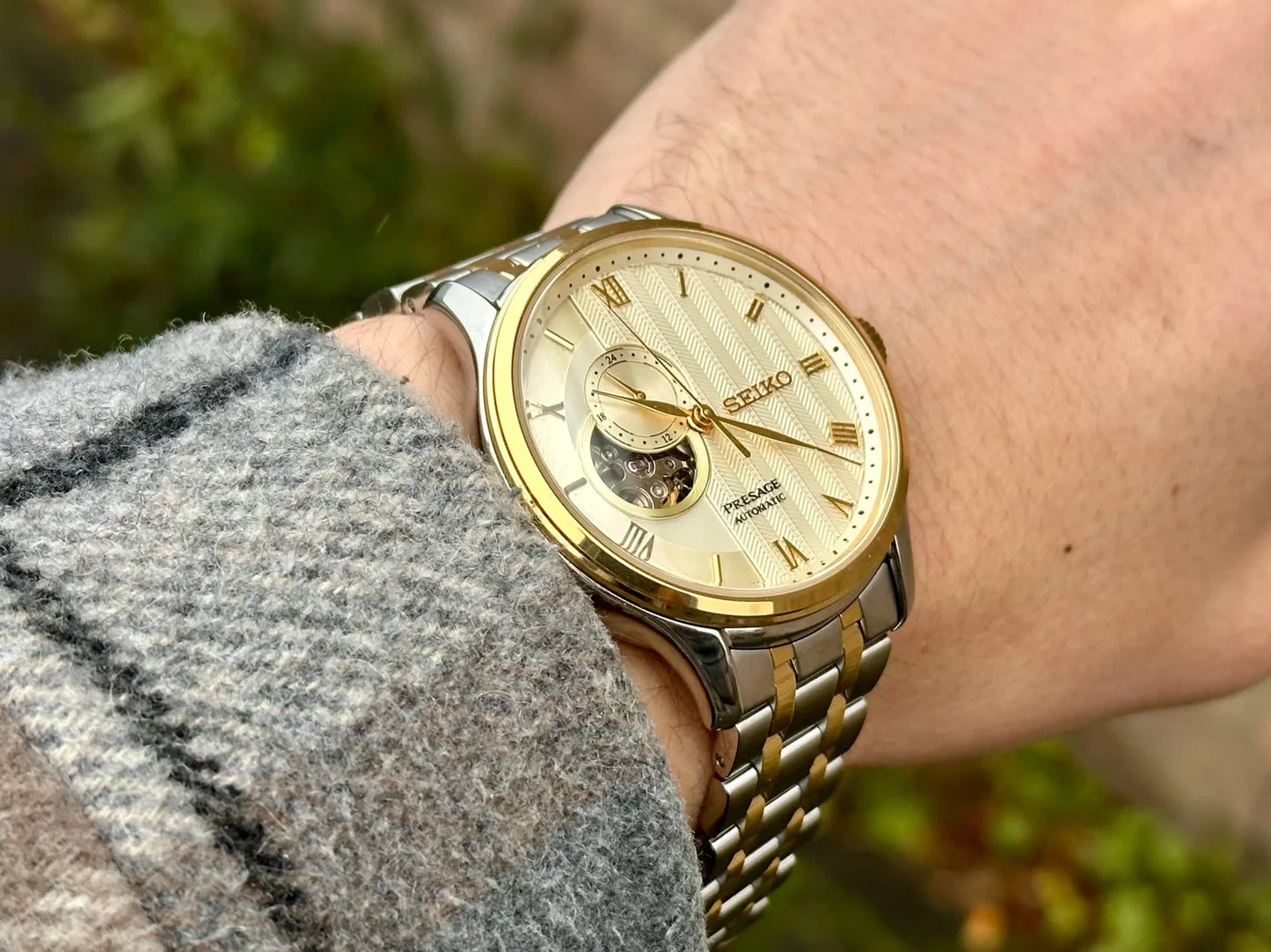 Seiko Presage SSA464 Japanese Garden – ivory-gold dial automatic watch with open-heart display, 24-hour sub-dial, dual-curved sapphire crystal, two-tone bracelet, and see-through caseback.