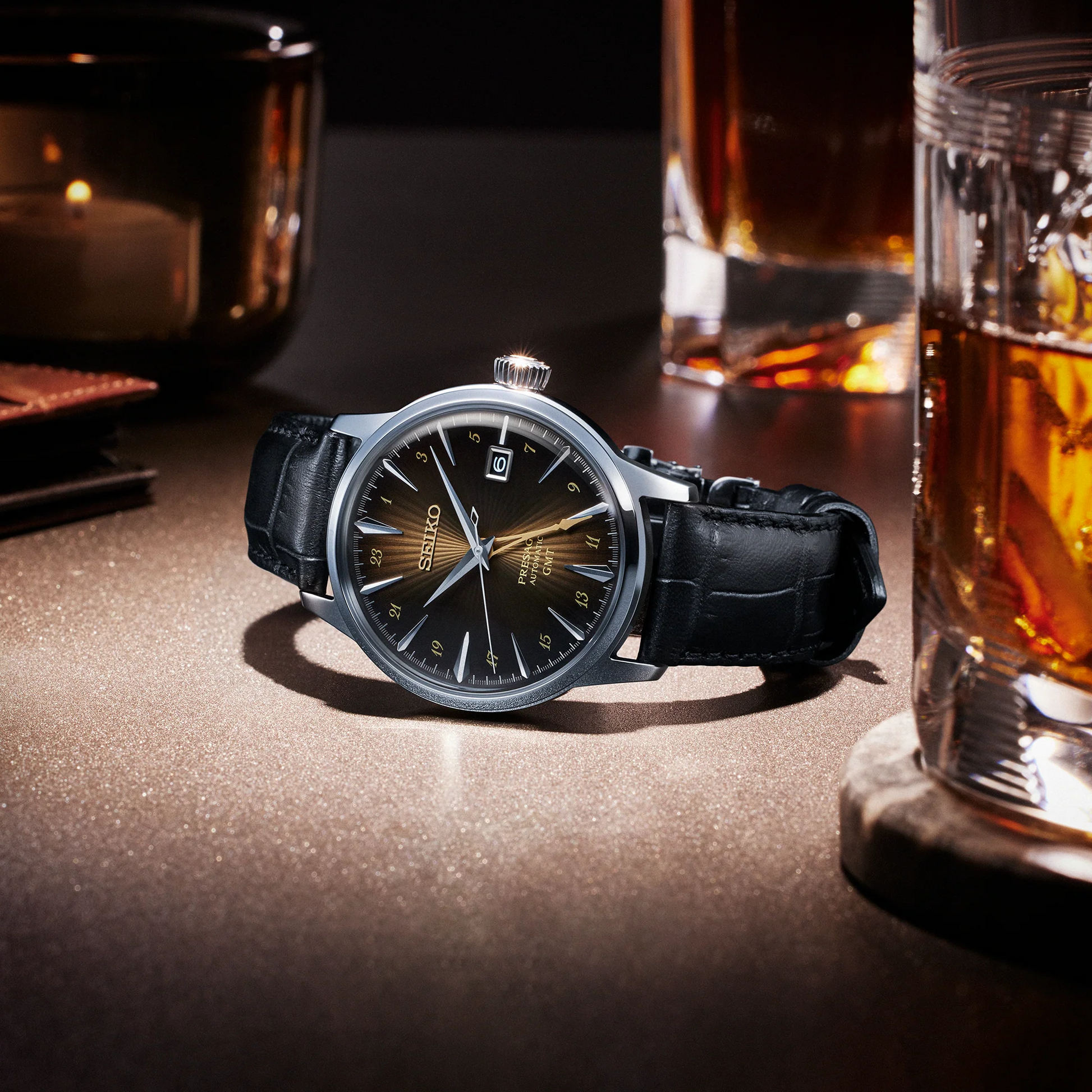 SEIKO SSK039 Presage Cocktail Time GMT – brown sunburst dial inspired by the Rusty Nail cocktail, gold-tone GMT hand, black leather strap, automatic movement, and 50m water resistance.