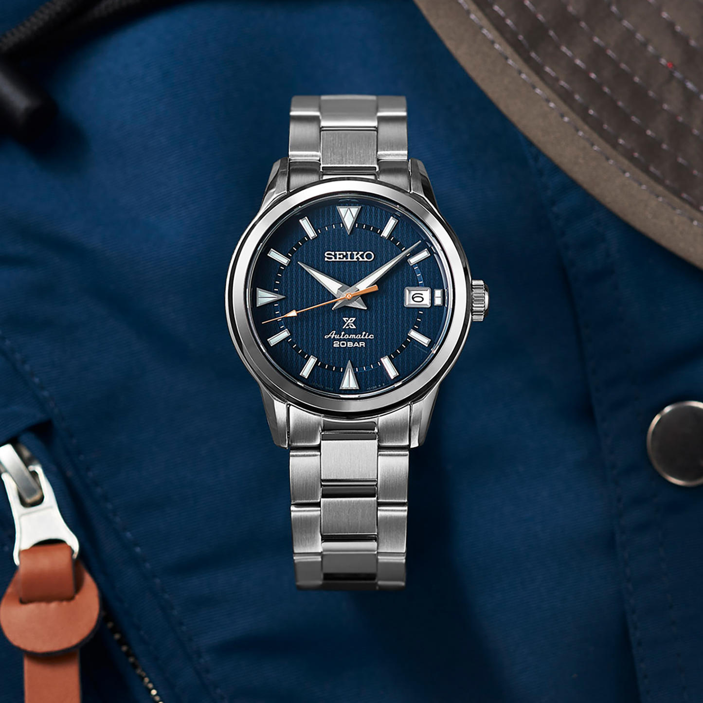 SEIKO Prospex SPB249 Alpinist – blue patterned dial with mountain-shaped markers, stainless steel case and bracelet, curved sapphire crystal, automatic movement, and 200m water resistance.