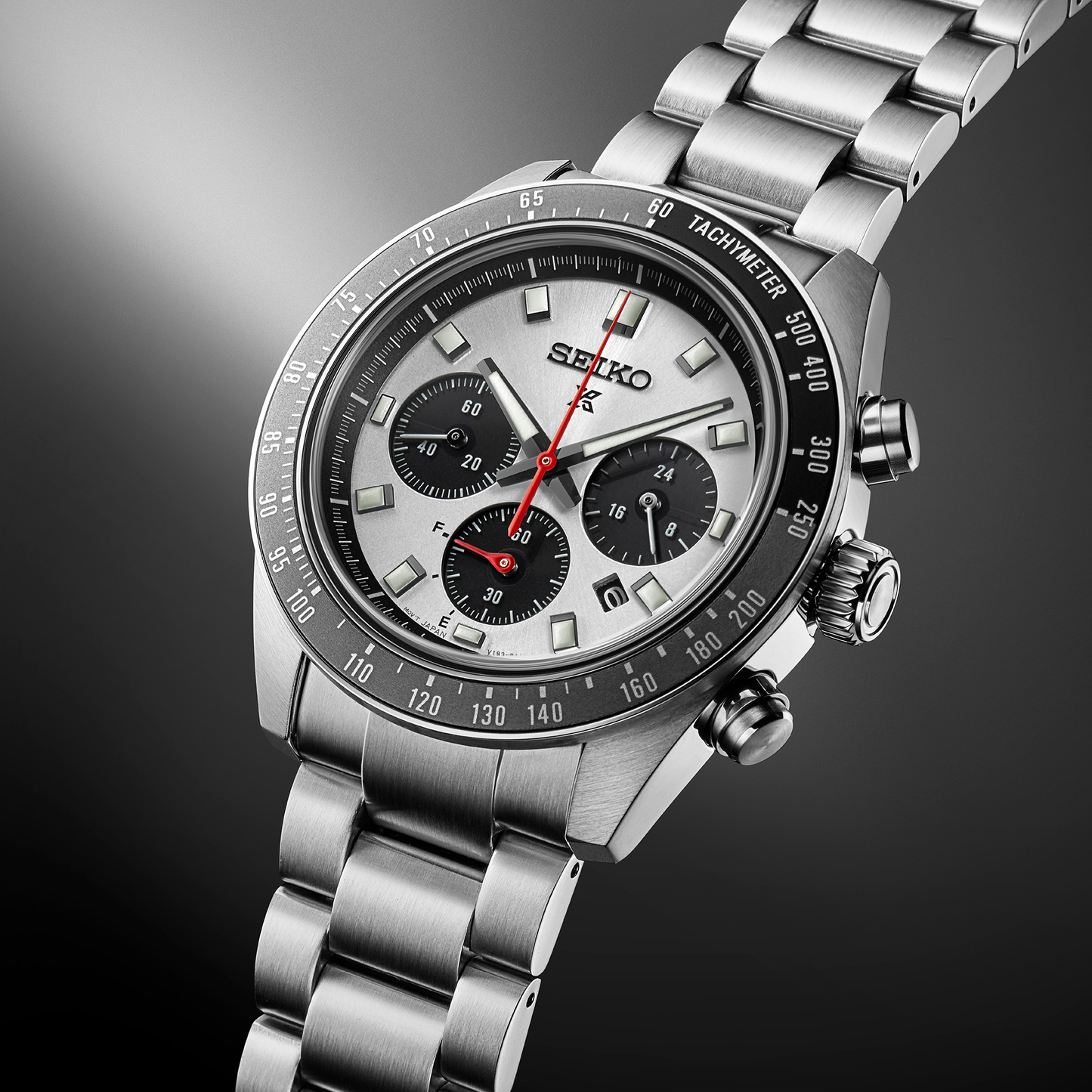 Seiko SSC911 – Prospex Speedtimer Solar Chronograph with silver sunray dial, black subdials, red chronograph hand, and black/gray tachymeter bezel; solar-powered with stainless steel bracelet.