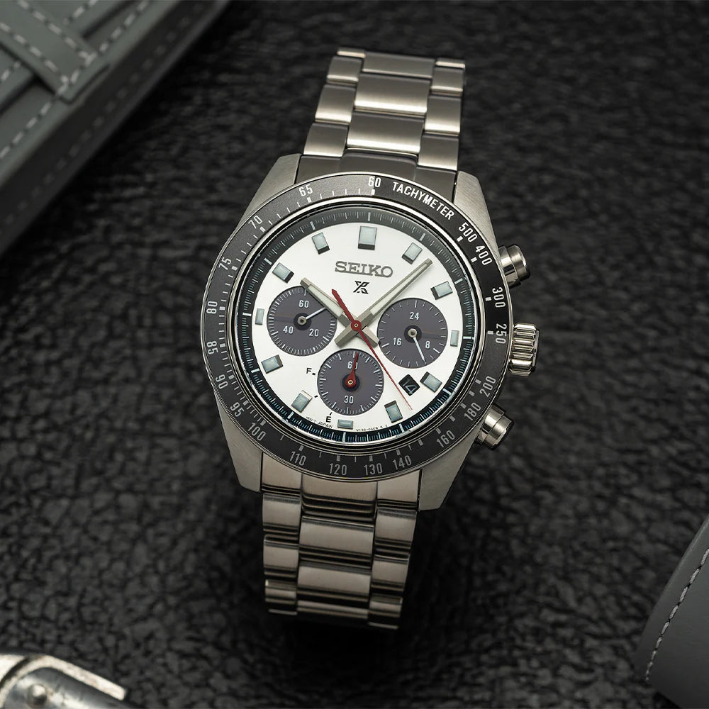 Seiko SSC911 – Prospex Speedtimer Solar Chronograph with silver sunray dial, black subdials, red chronograph hand, and black/gray tachymeter bezel; solar-powered with stainless steel bracelet.
