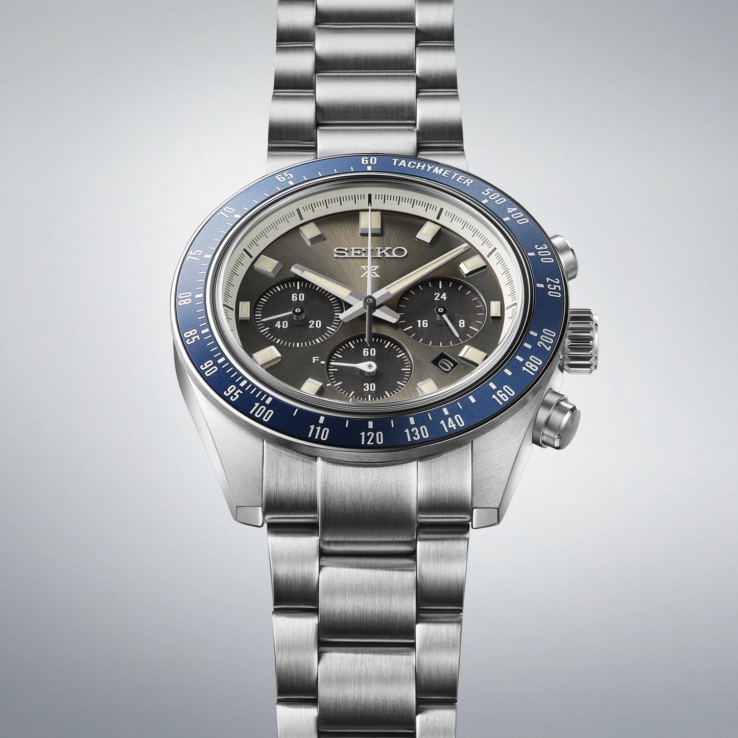 Seiko SSC939 – Prospex Speedtimer Solar Chronograph with gray sunray dial, navy blue tachymeter bezel, stainless steel case and bracelet; solar-powered with chronograph and date functions.