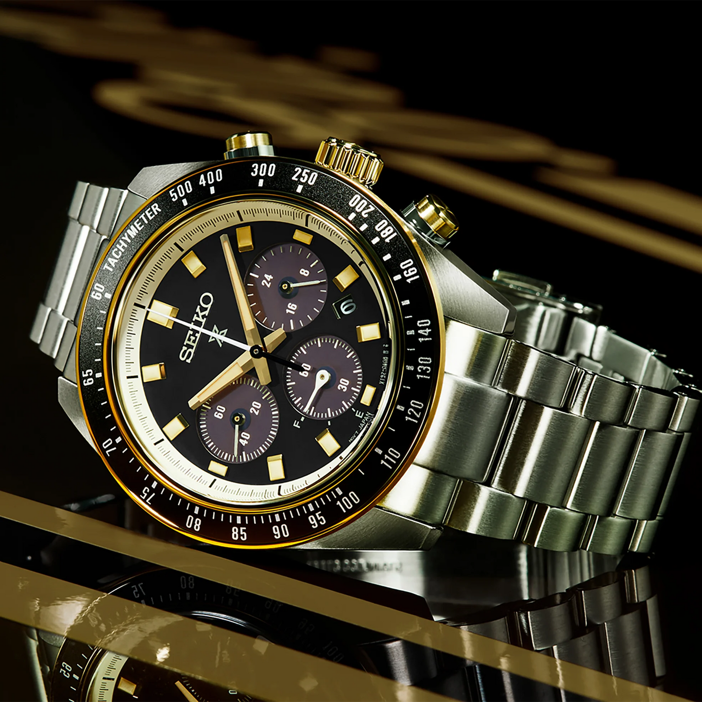 Seiko SSC941 – Prospex Speedtimer Solar Chronograph with black dial, gold accents, black tachymeter bezel, and two-tone stainless steel case; motorsport-inspired solar-powered design with chronograph functions.”