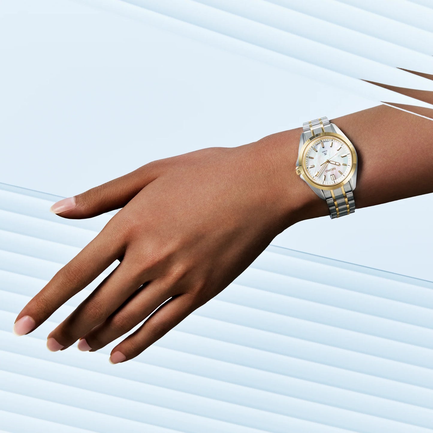 SEIKO Prospex SUR608 Sea Series – 34mm two-tone stainless steel case and bracelet, white mother-of-pearl dial with gold accents, curved sapphire crystal, quartz movement, and 200m water resistance.