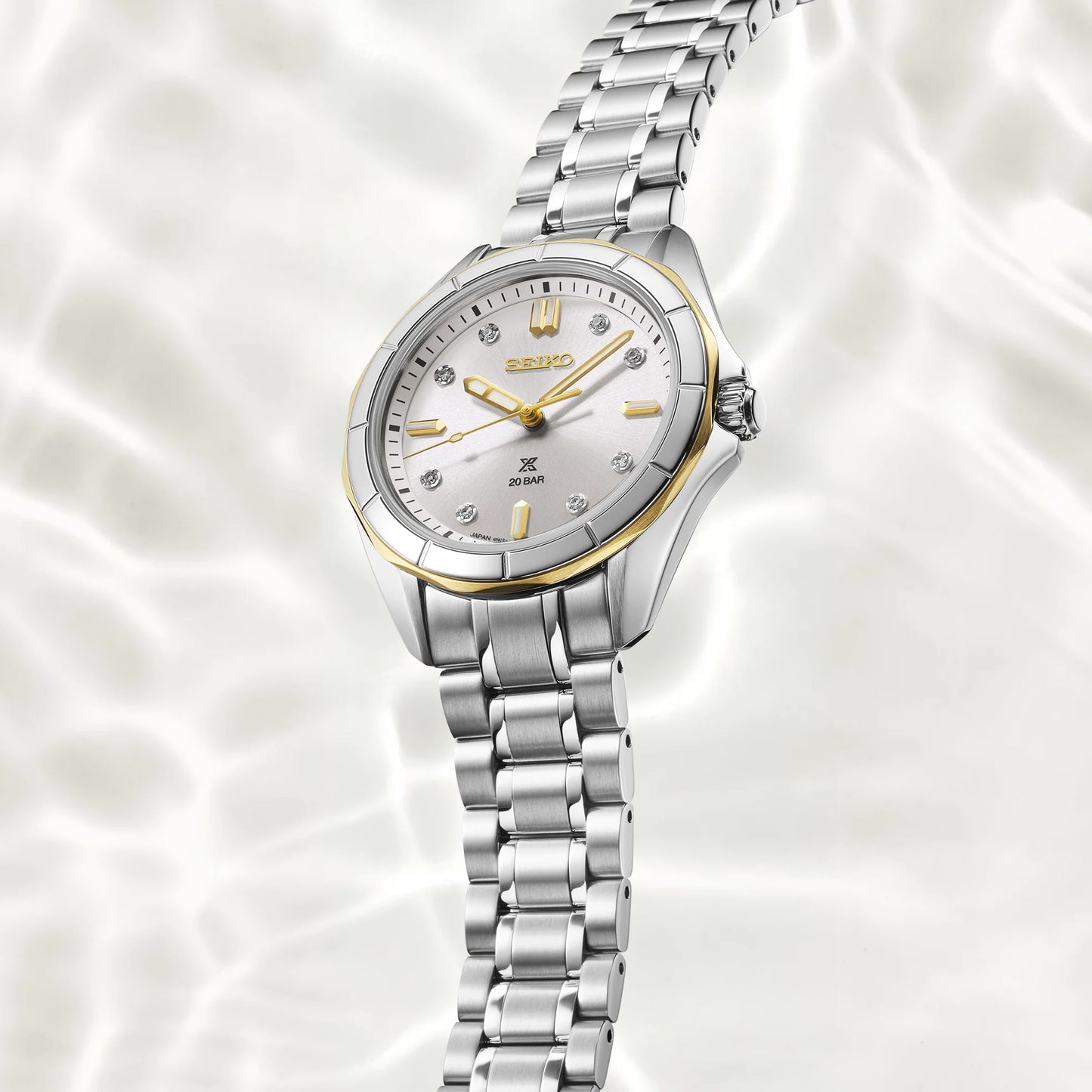 Silver Seiko watch with a white face on a white background