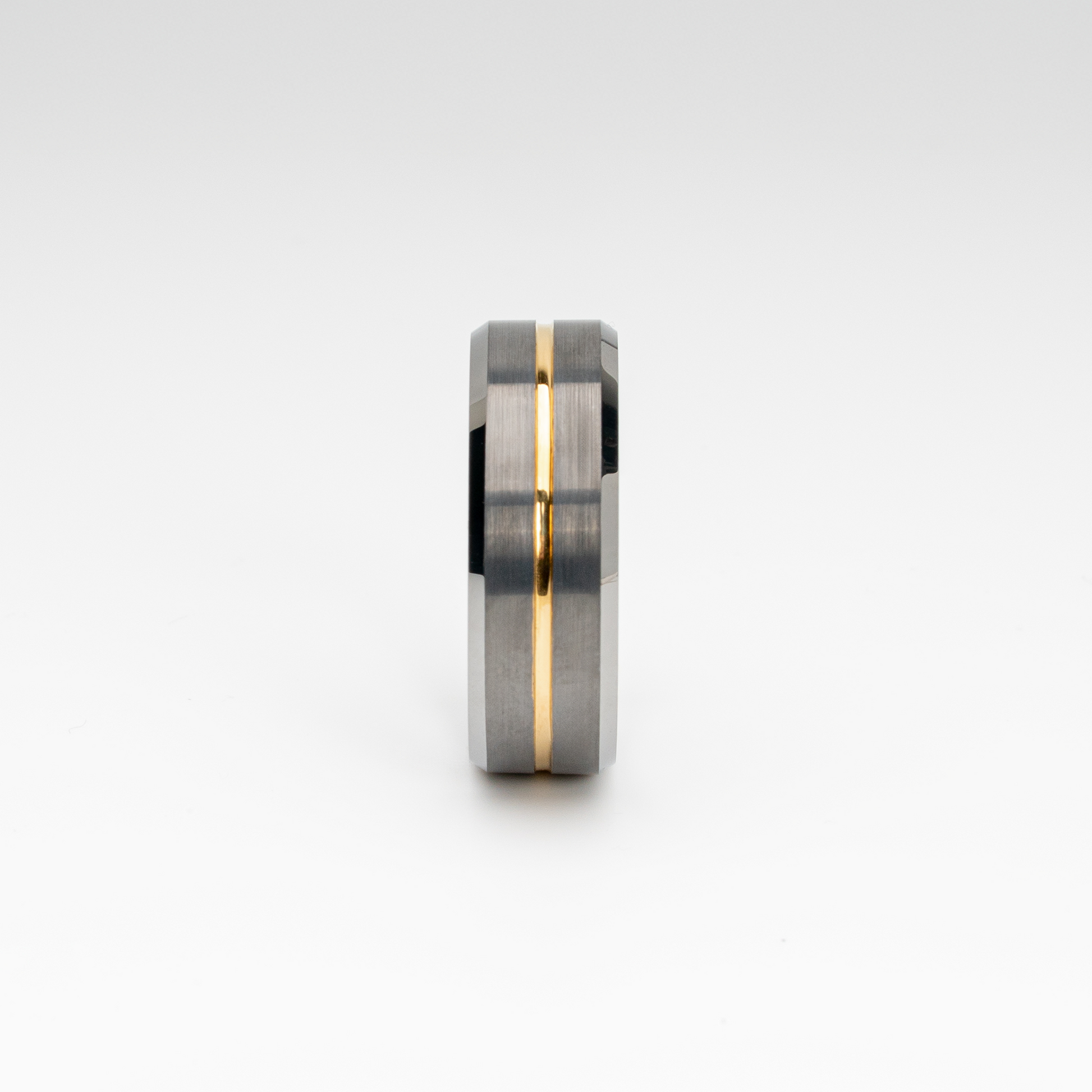 A brushed silver tungsten carbide ring with a polished beveled edge and a gold-tone center groove. Modern two-tone design, durable, scratch-resistant, and comfort fit—ideal as a men’s wedding band, anniversary ring, or stylish fashion accessory.