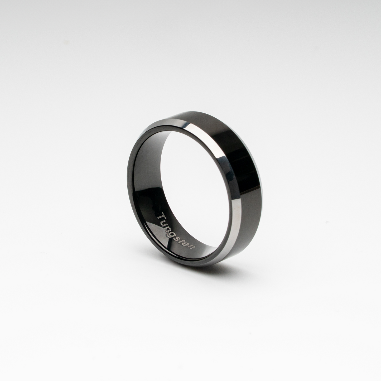 Polished black tungsten carbide ring with bold beveled edges. Minimalist, scratch-resistant, and comfort fit—perfect as a men’s wedding band, promise ring, or modern unisex fashion accessory.