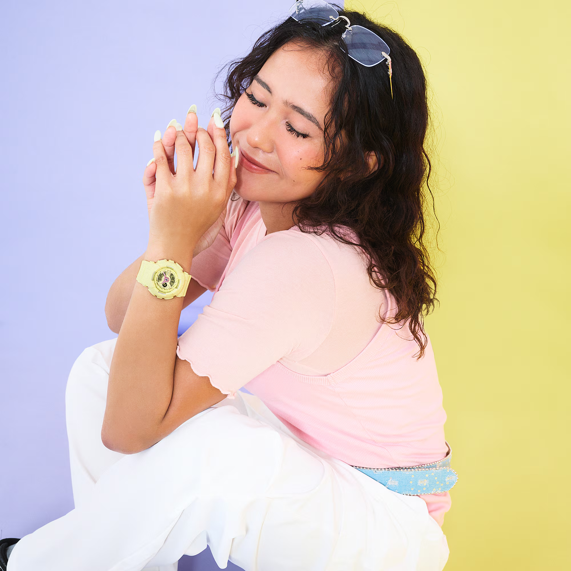 Woman sitting on a chair with a colorful background