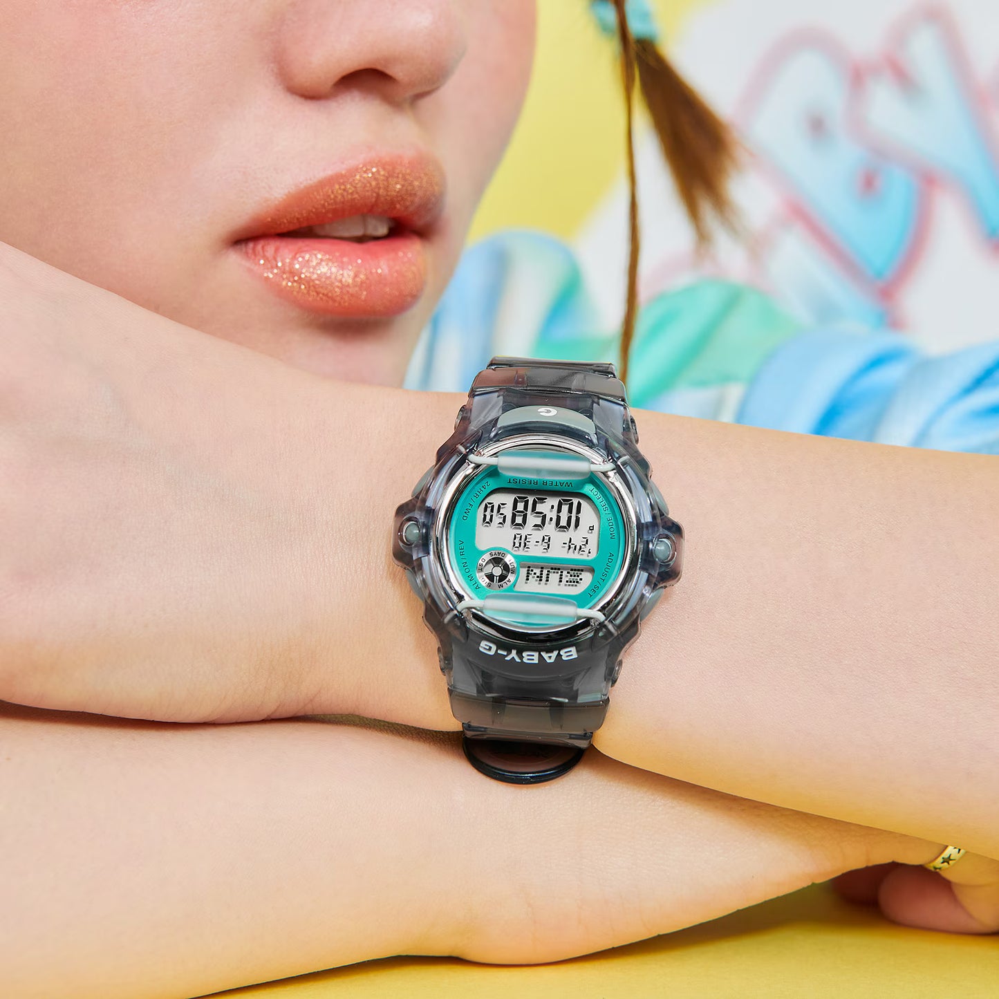 Person wearing a Casio watch with a colorful background