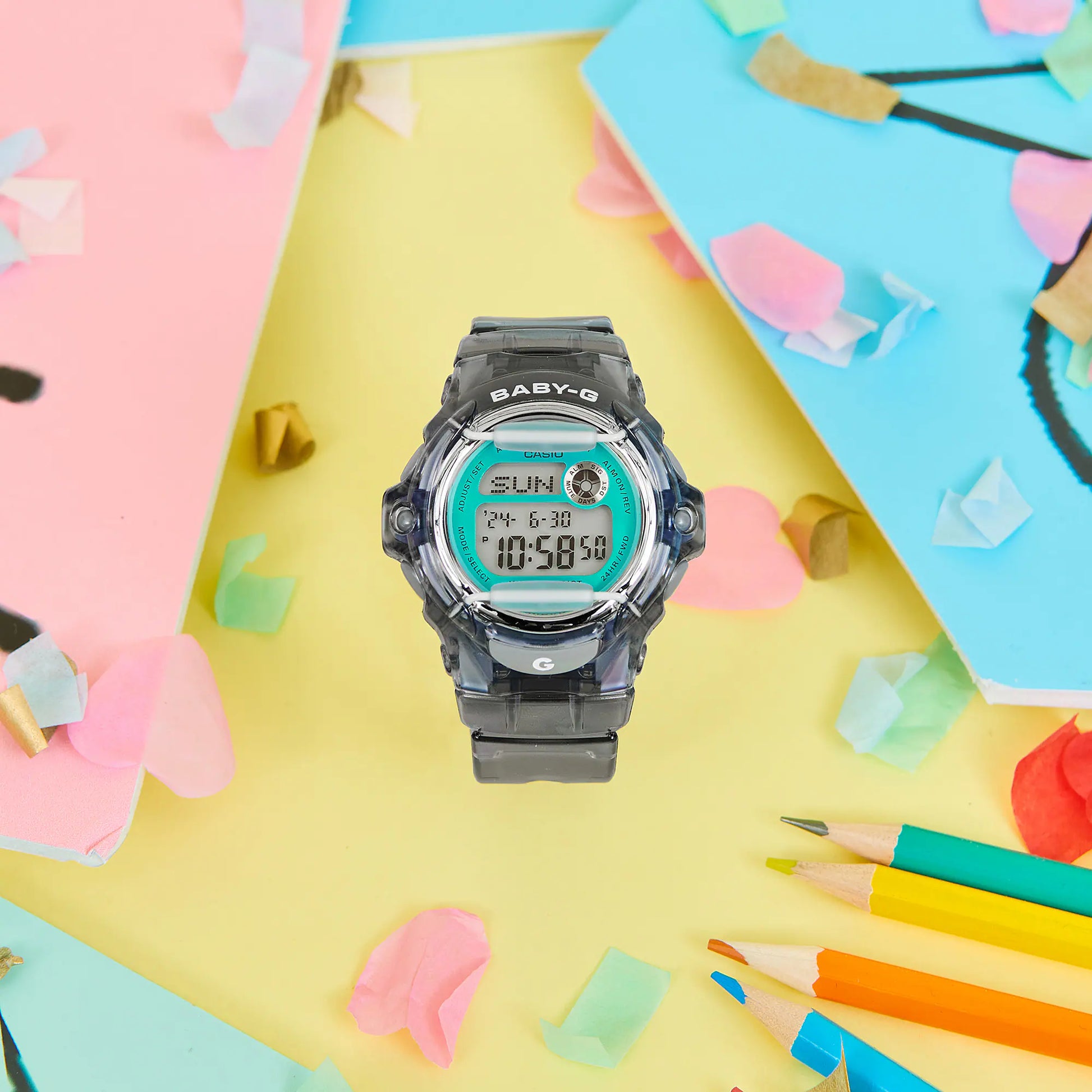 Digital watch with a colorful background featuring stationery items