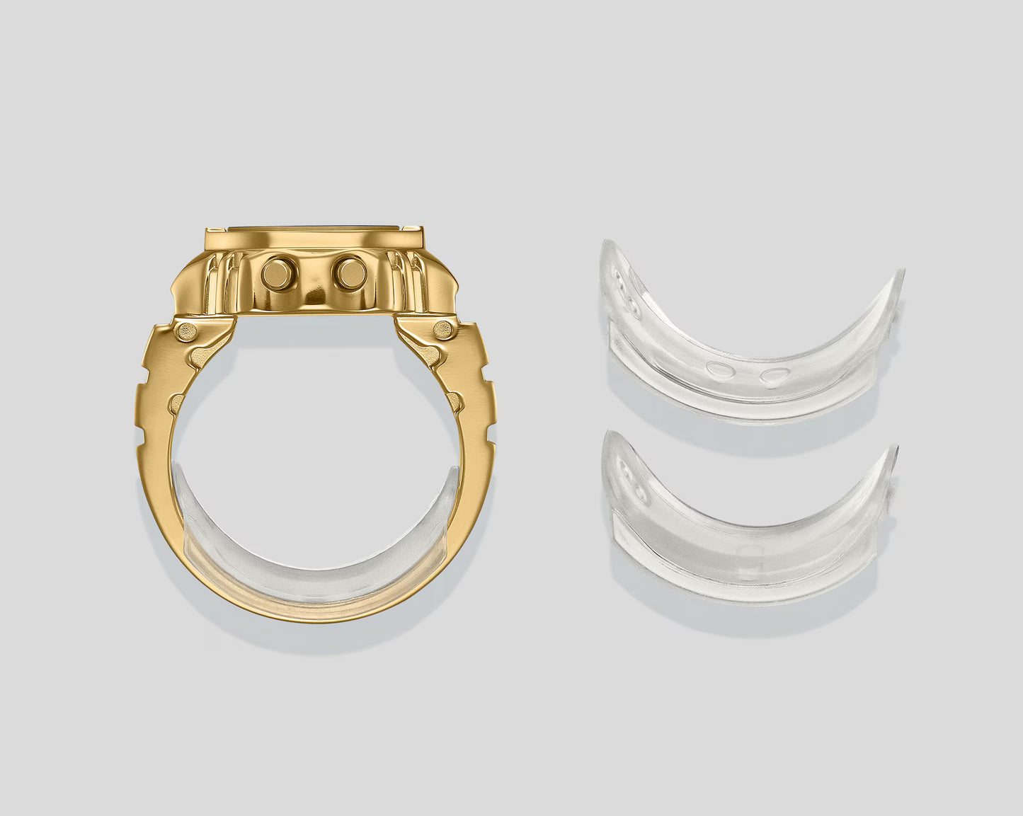 Gold and silver ring components on a light gray background