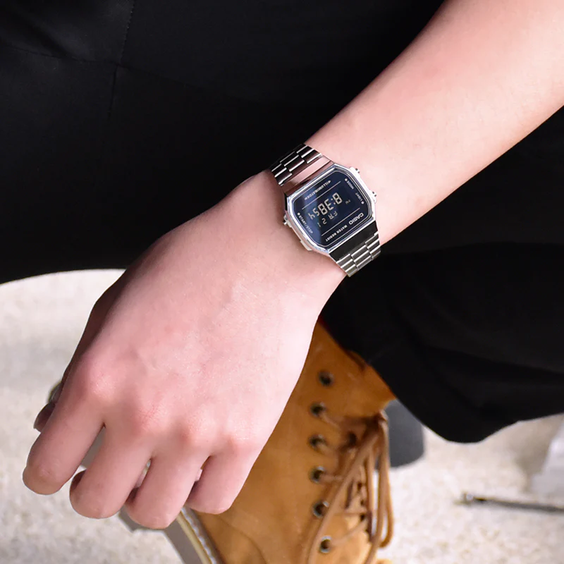 Digital watch on a wrist with a blurred background