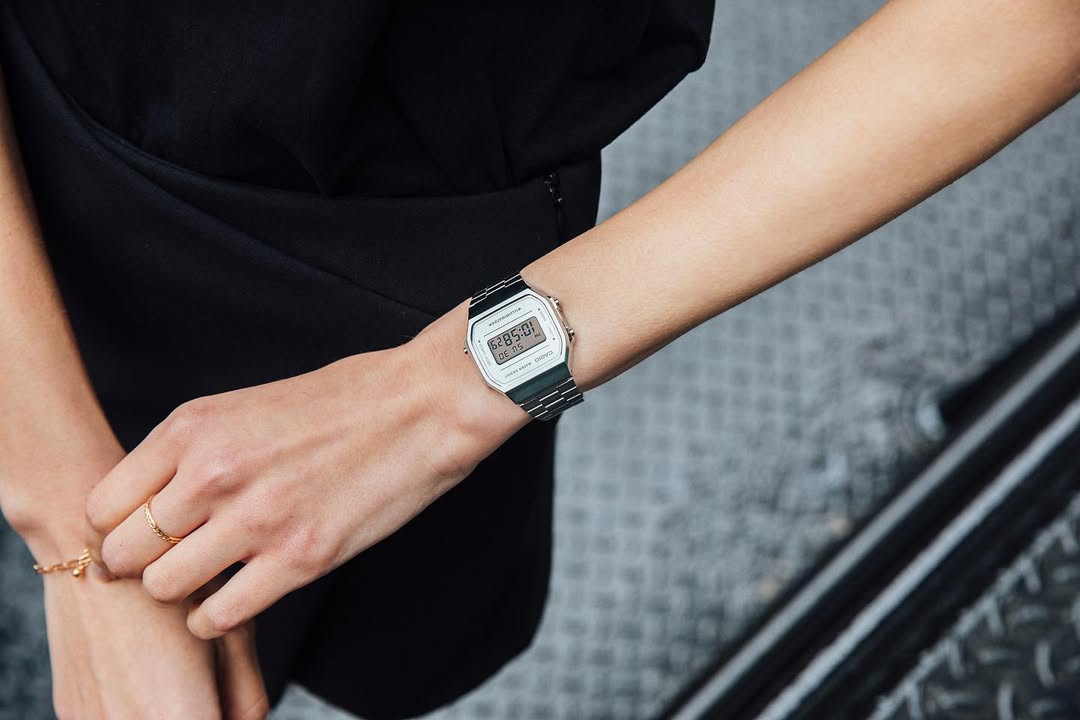 Person wearing a vintage-style watch on a blurred background